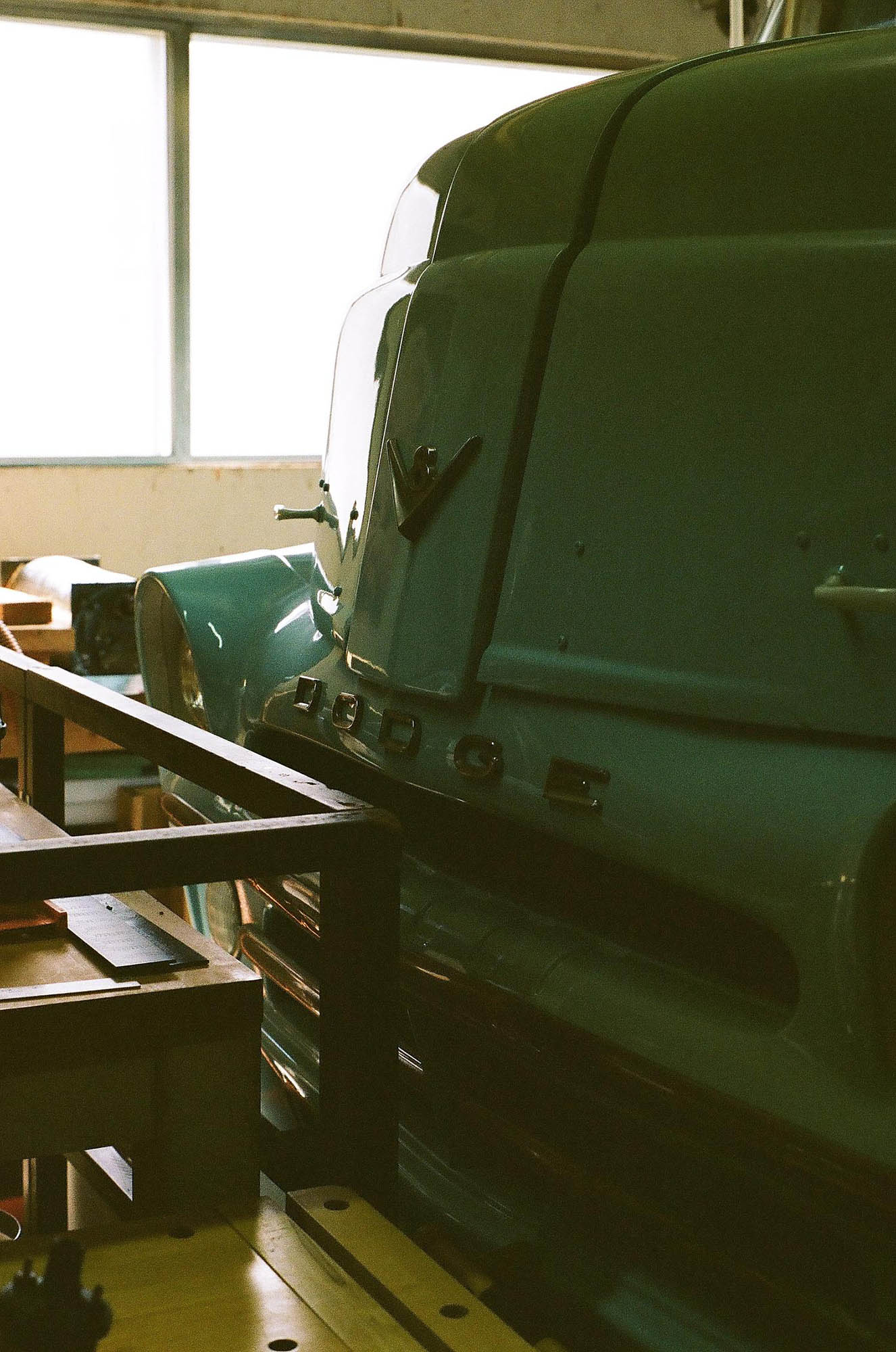 A green 1950s Dodge truck in a garage