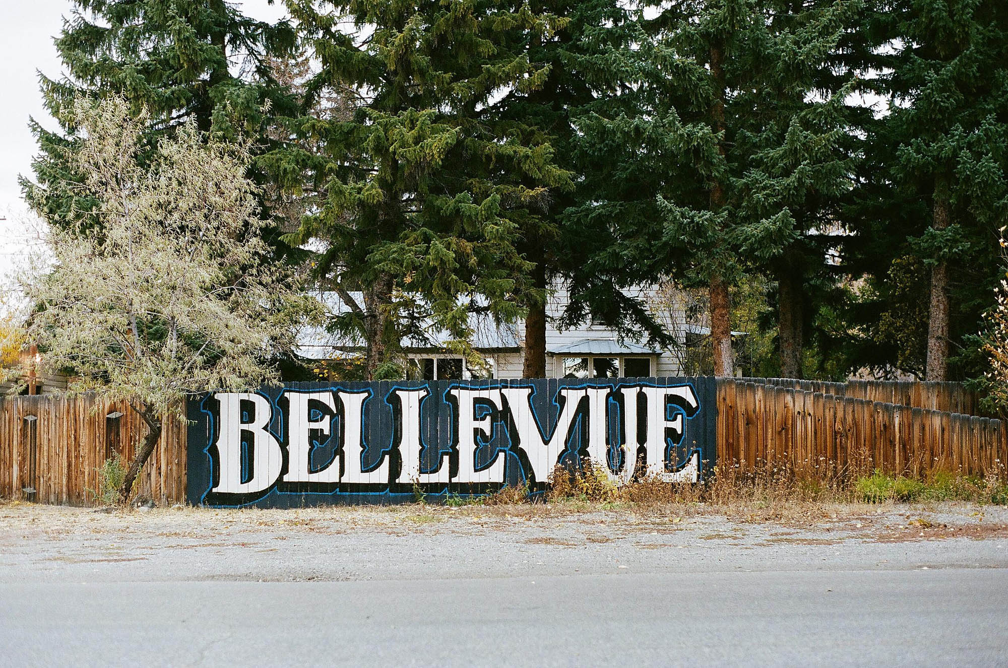 A wood fence with Bellevue painted on it