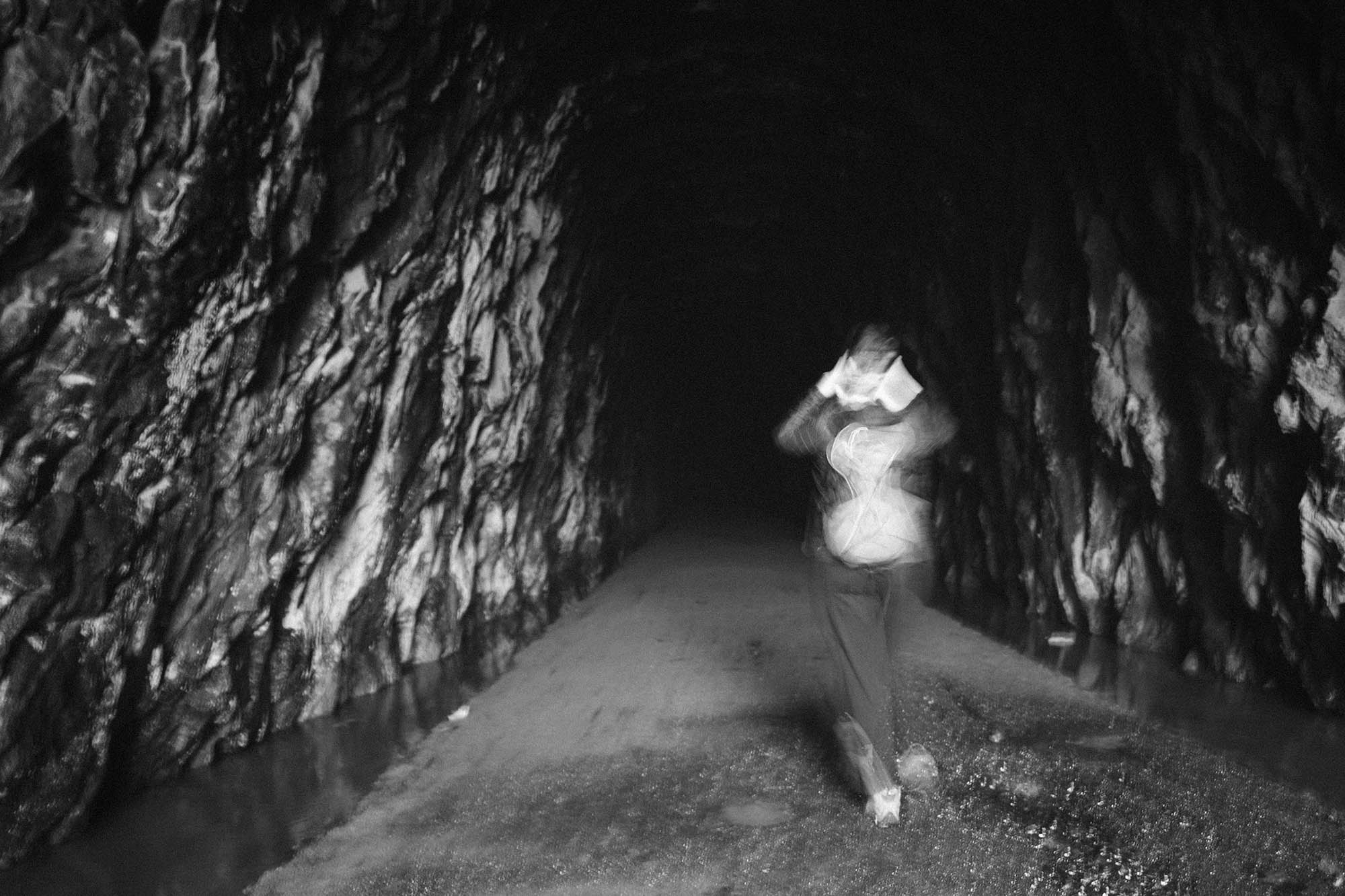 A person walking into the west entrance of the tunnel