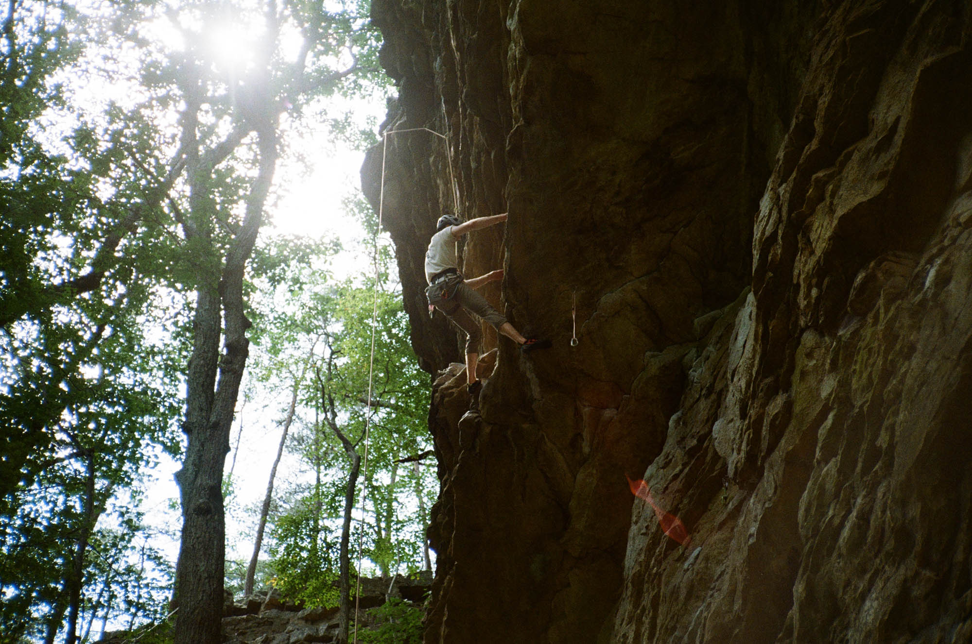 A person climbing a steep overhang on a rock wall
