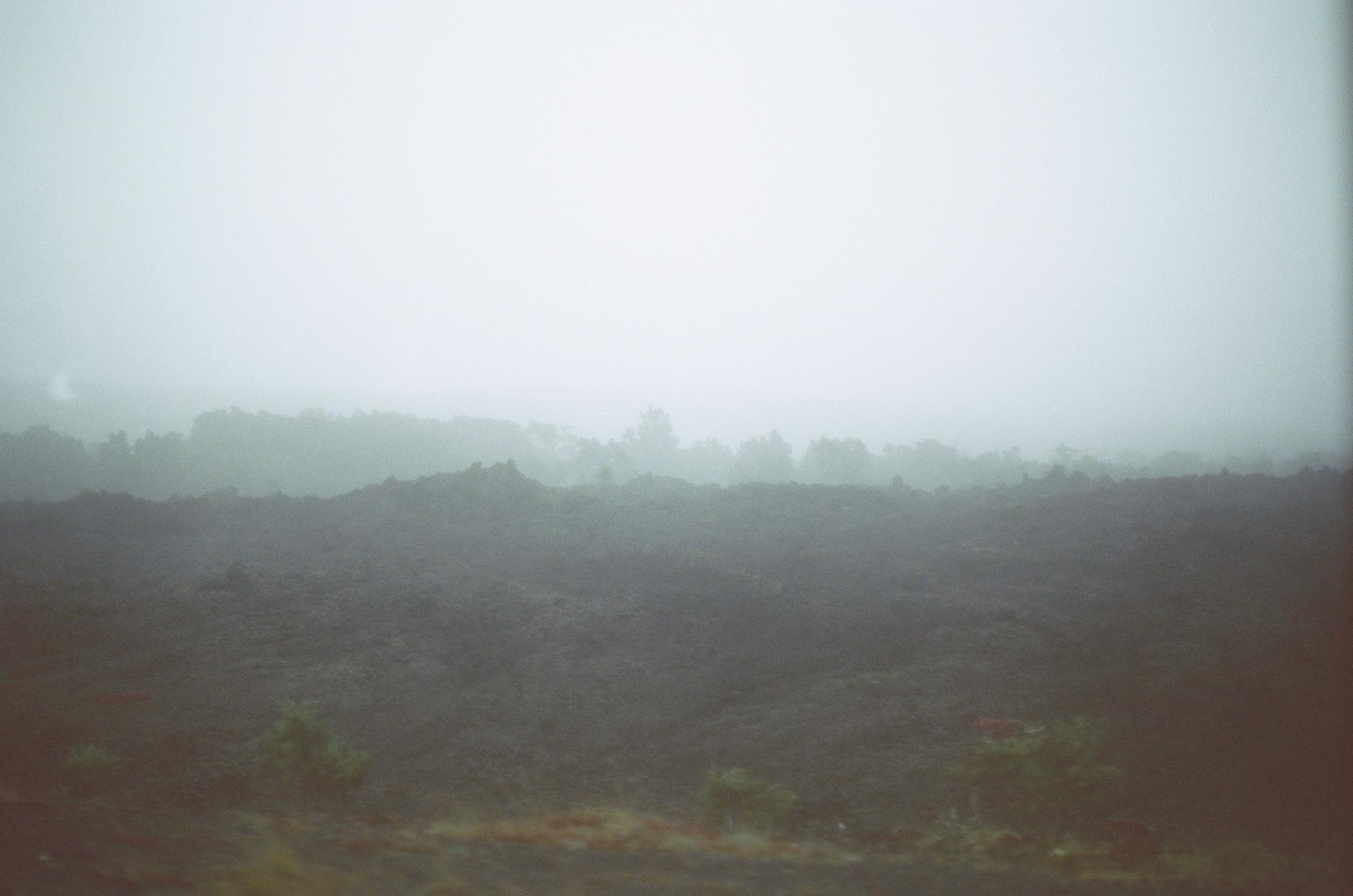 A very foggy landscape with hardened lava