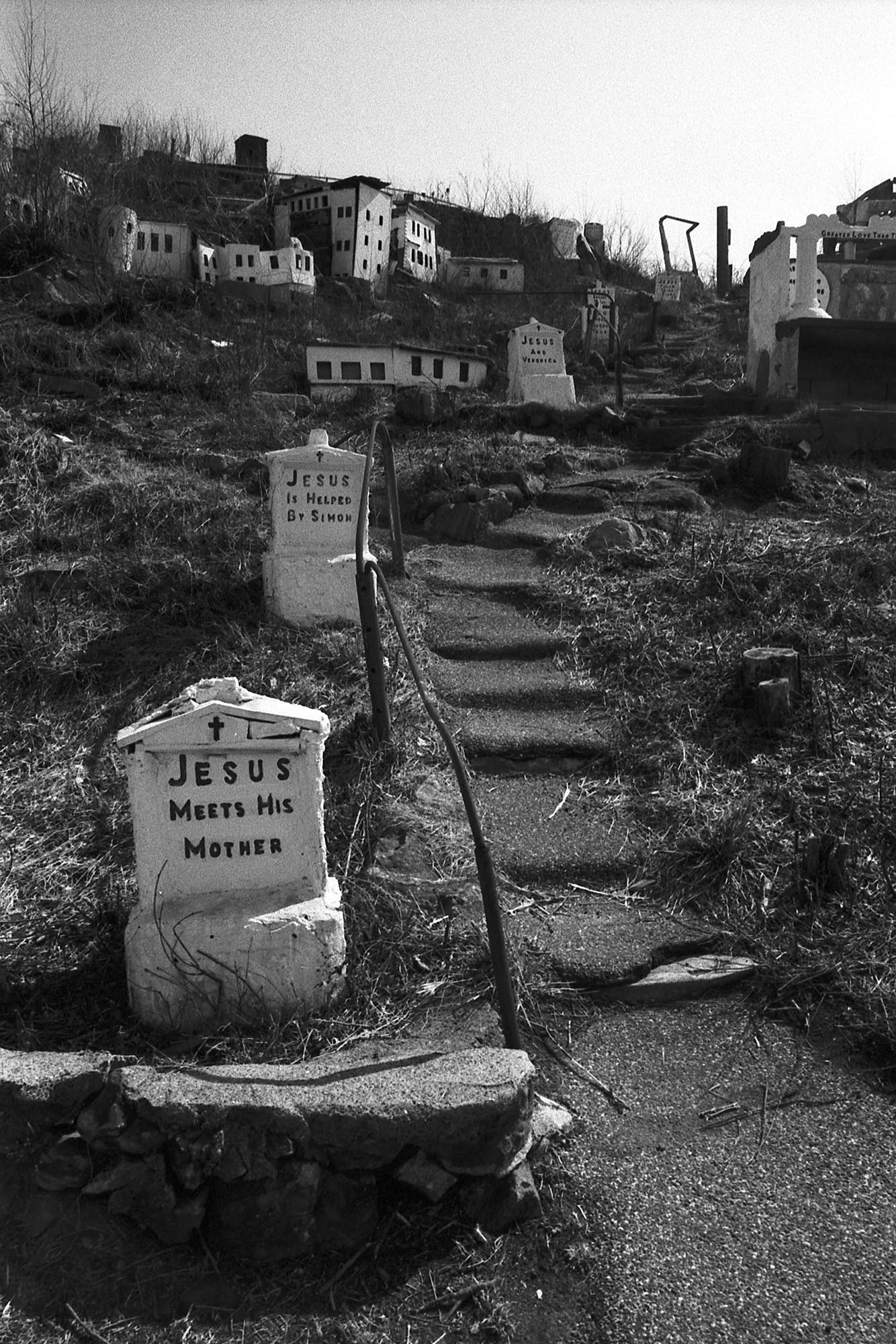 A concrete walkway on a hillside retracing the life of Jesus