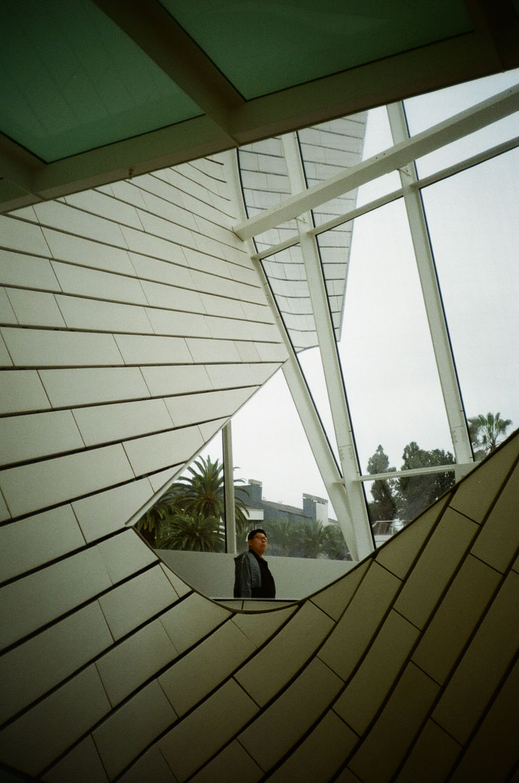 A museumgoer looking up at the twisting interior walkways