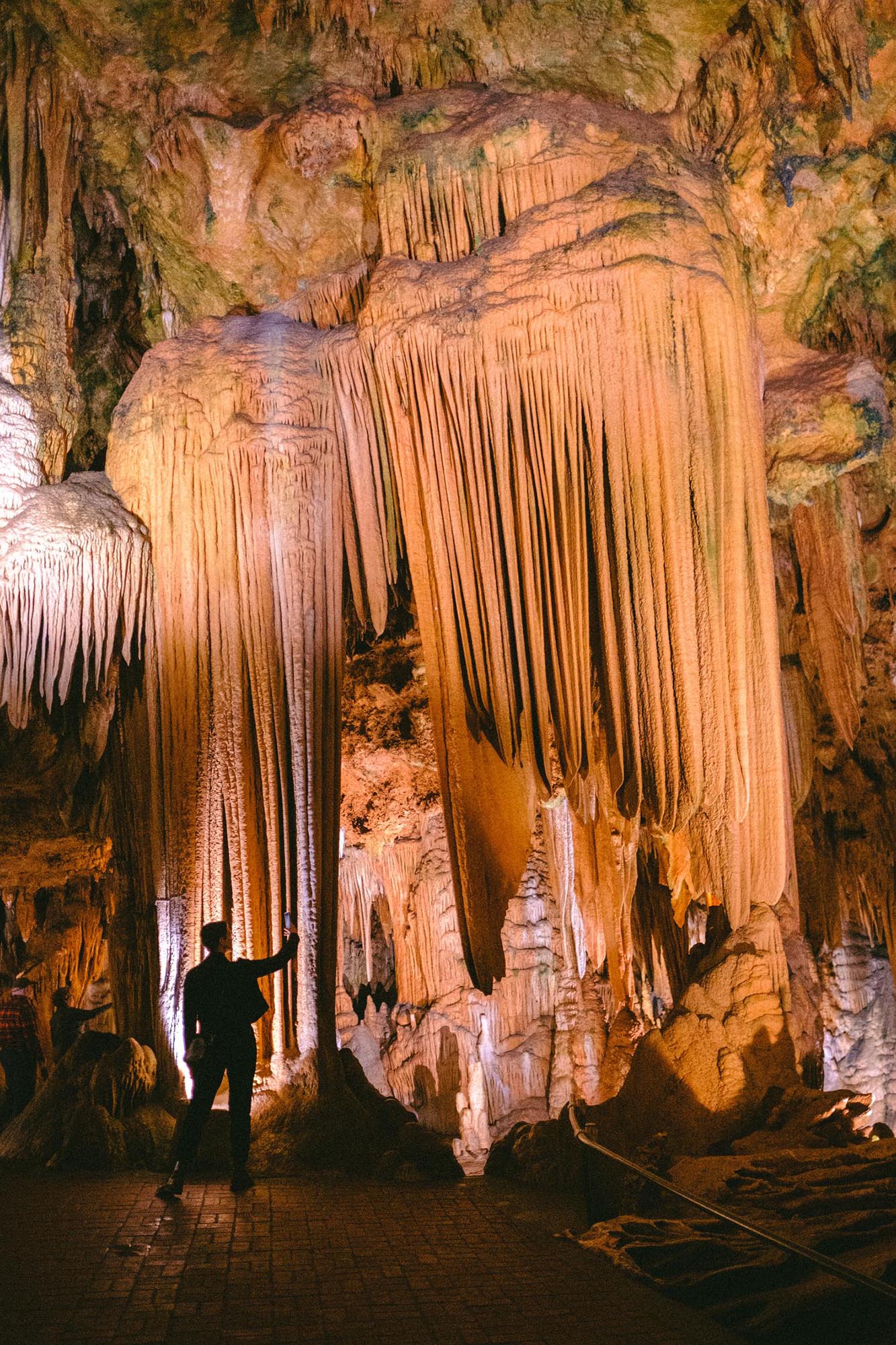 Stalactites with a human silhouette in front