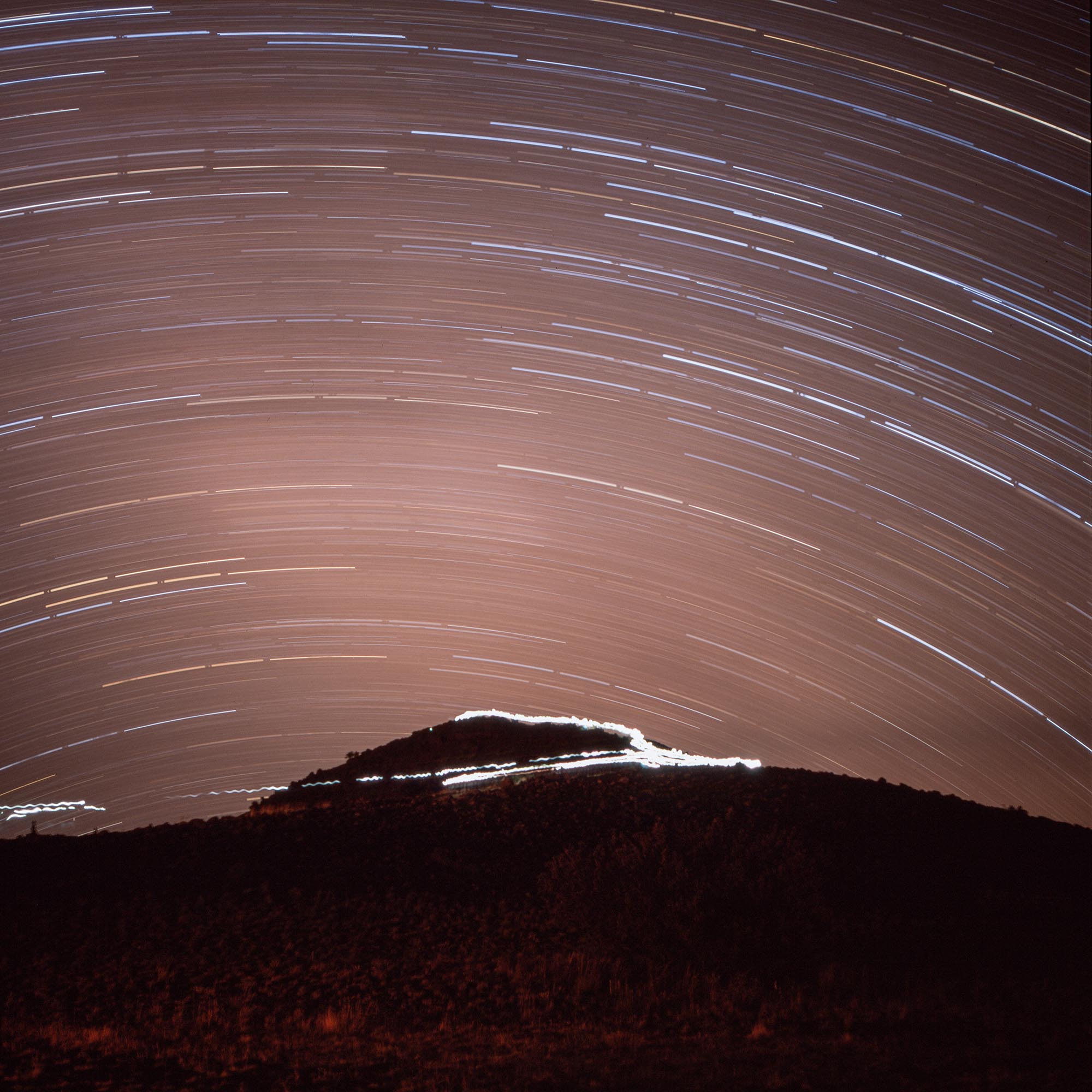 Star trails over a hill near the summit of Mauna Kea