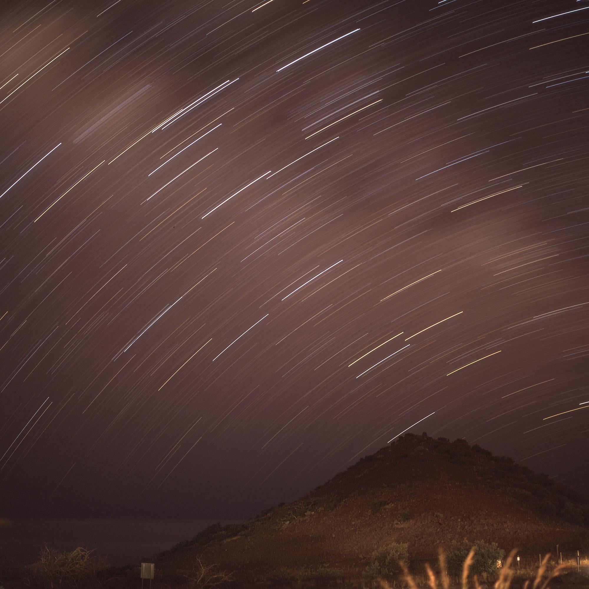 Star trails over a hill near the summit of Mauna Kea