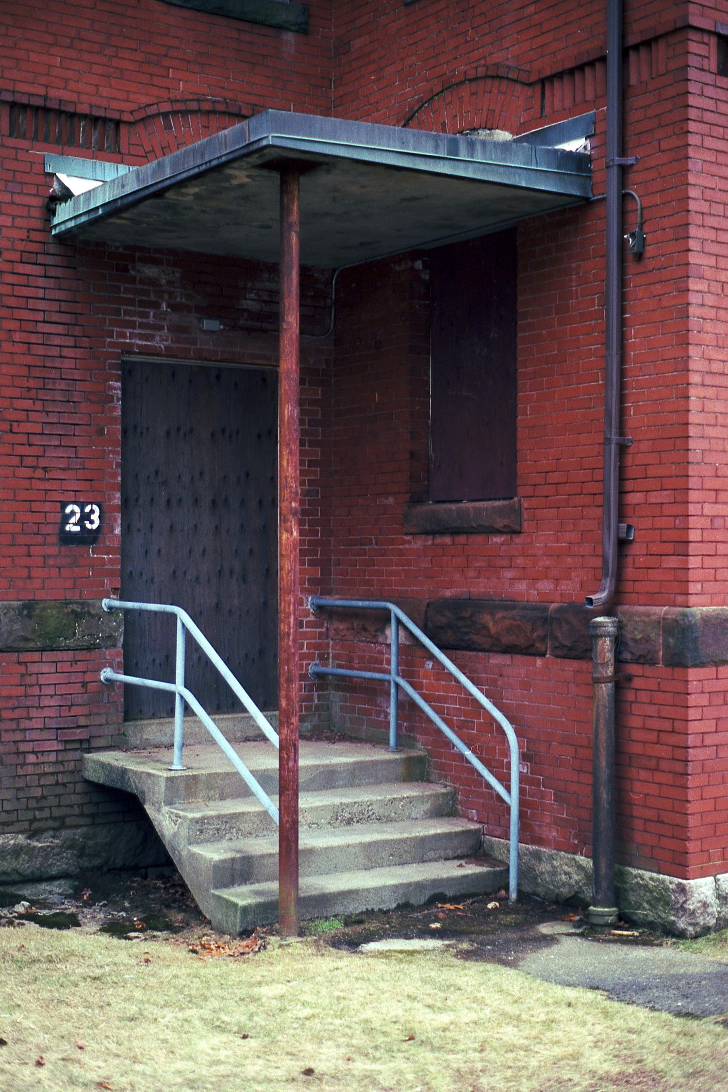 Steps leading up to a boarded up door