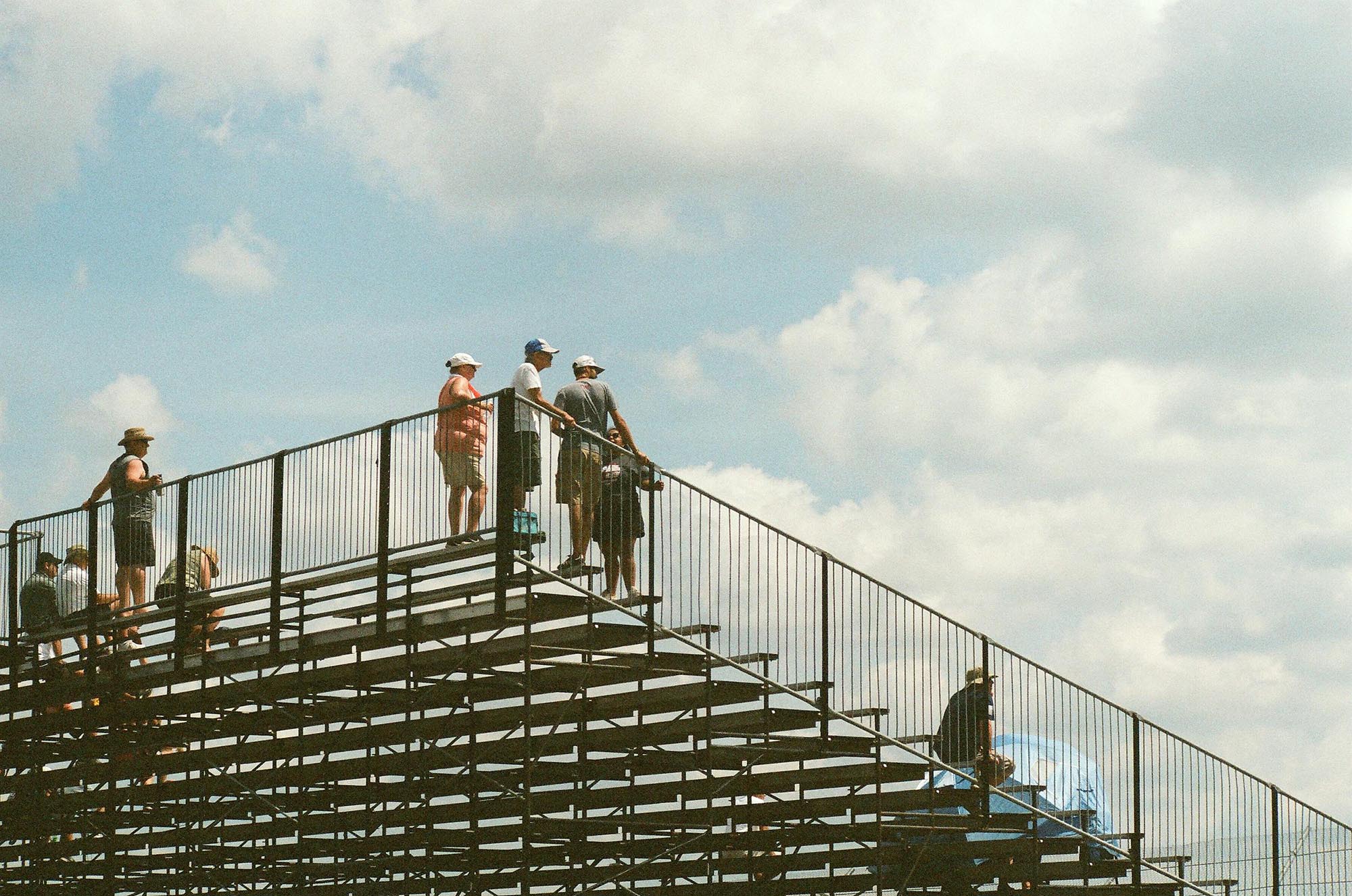 People standing at the top of the grandstand, from below