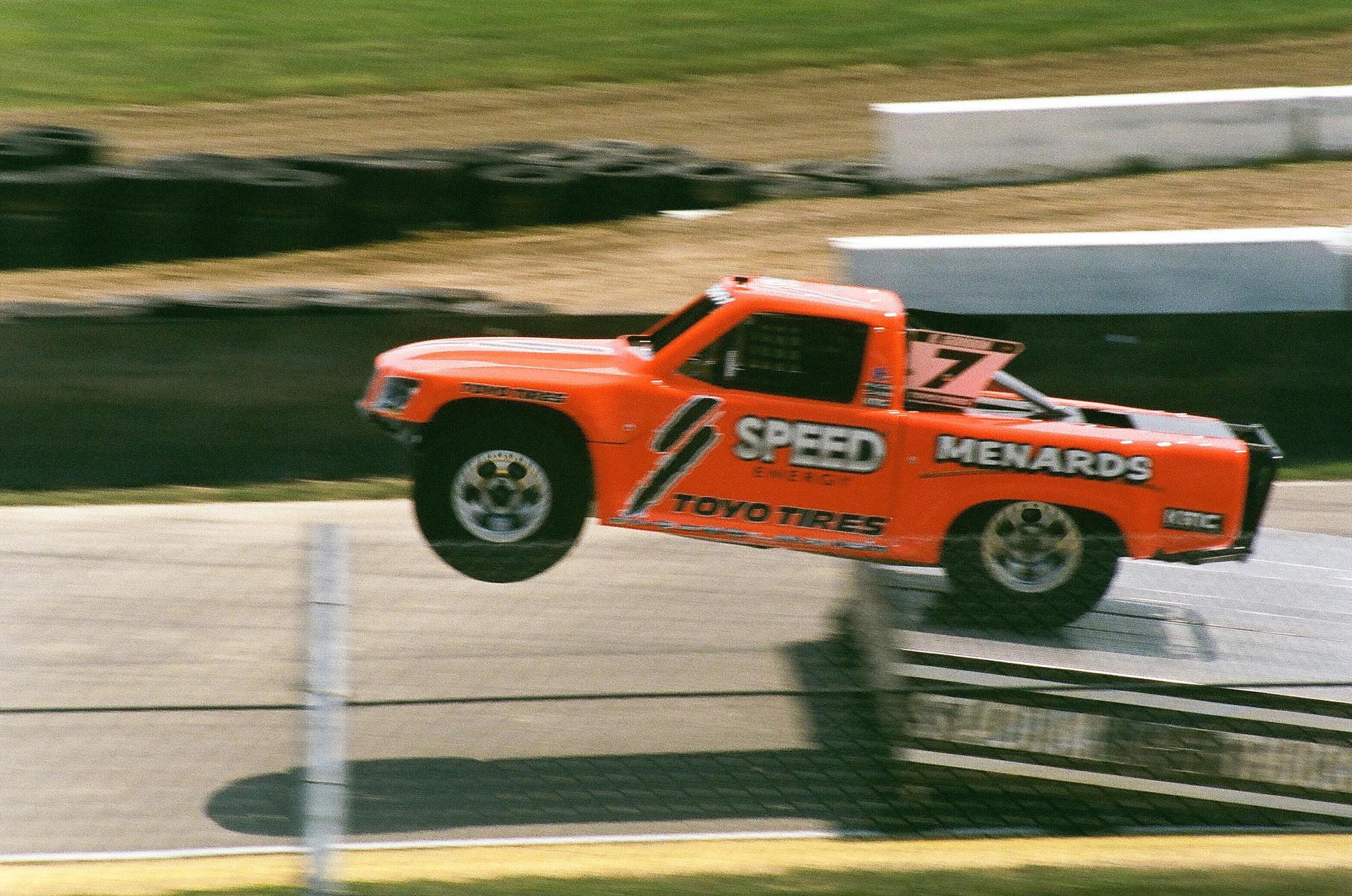 An Stadium Super Truck going off a jump