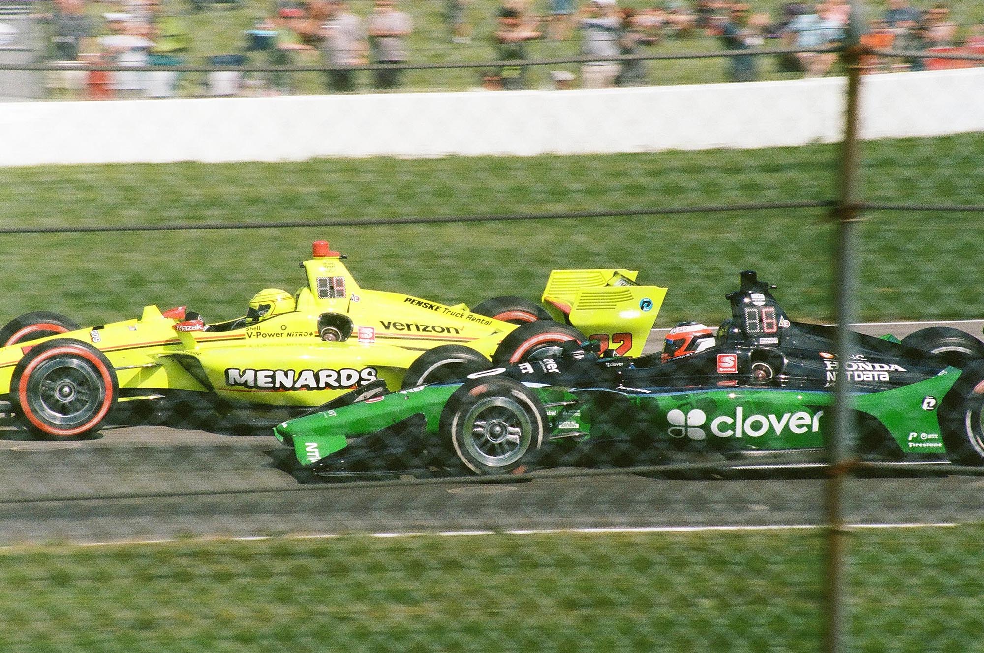 Two IndyCars battling on track