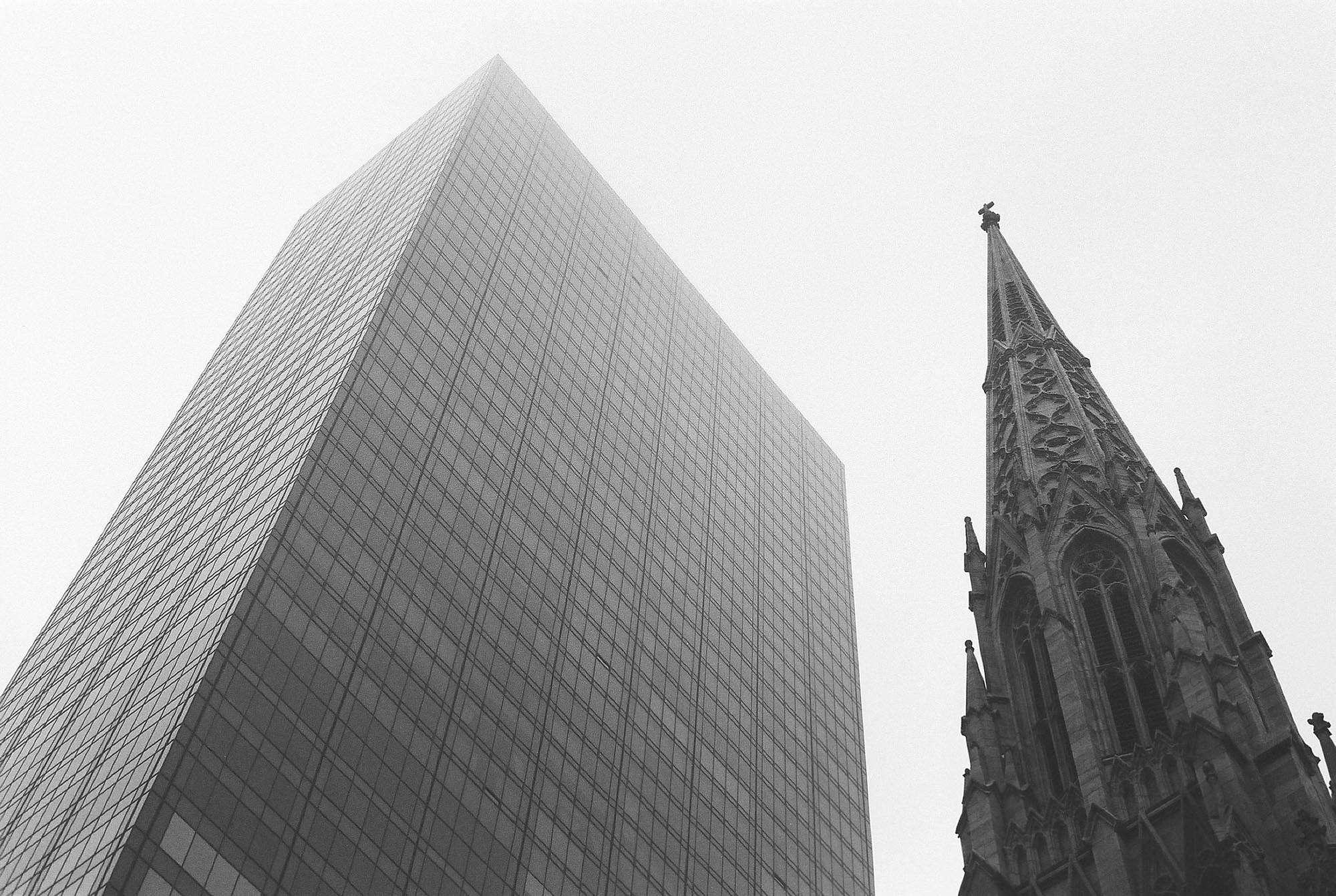 A modernist skyscraper and a church spire