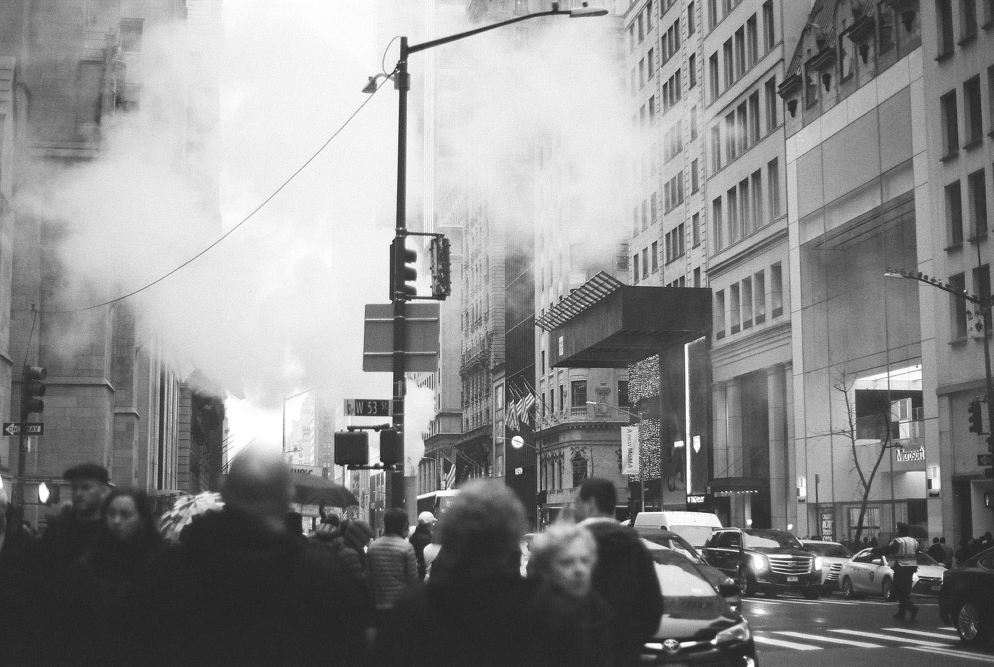 A New York street with mist rising from a stack