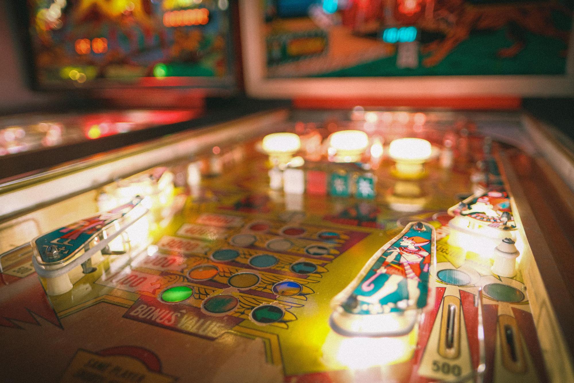 A close-up of the lit-up deck of the Cleopatra pinball machine