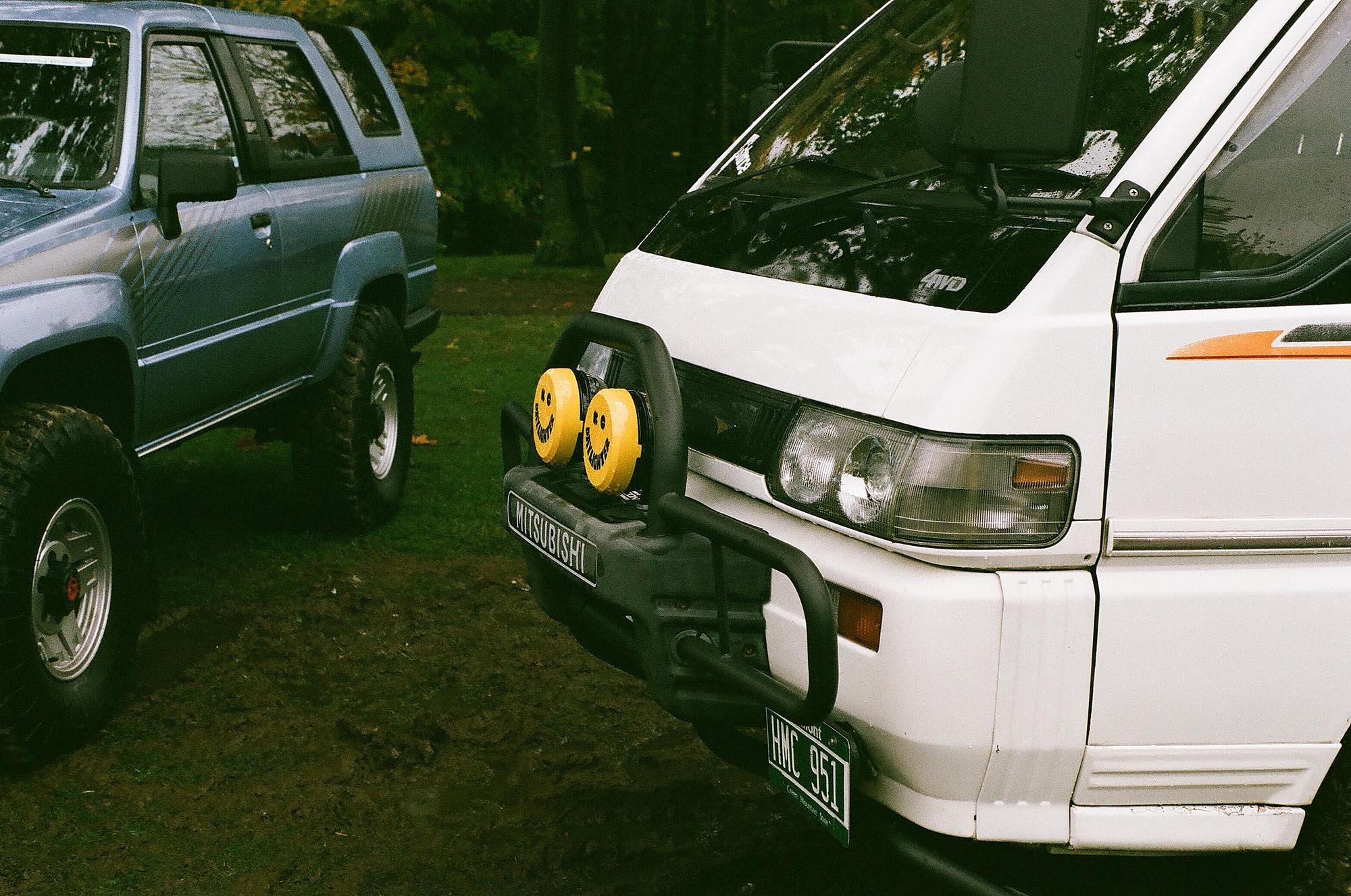 The front side profile of a white Mitsubishi van