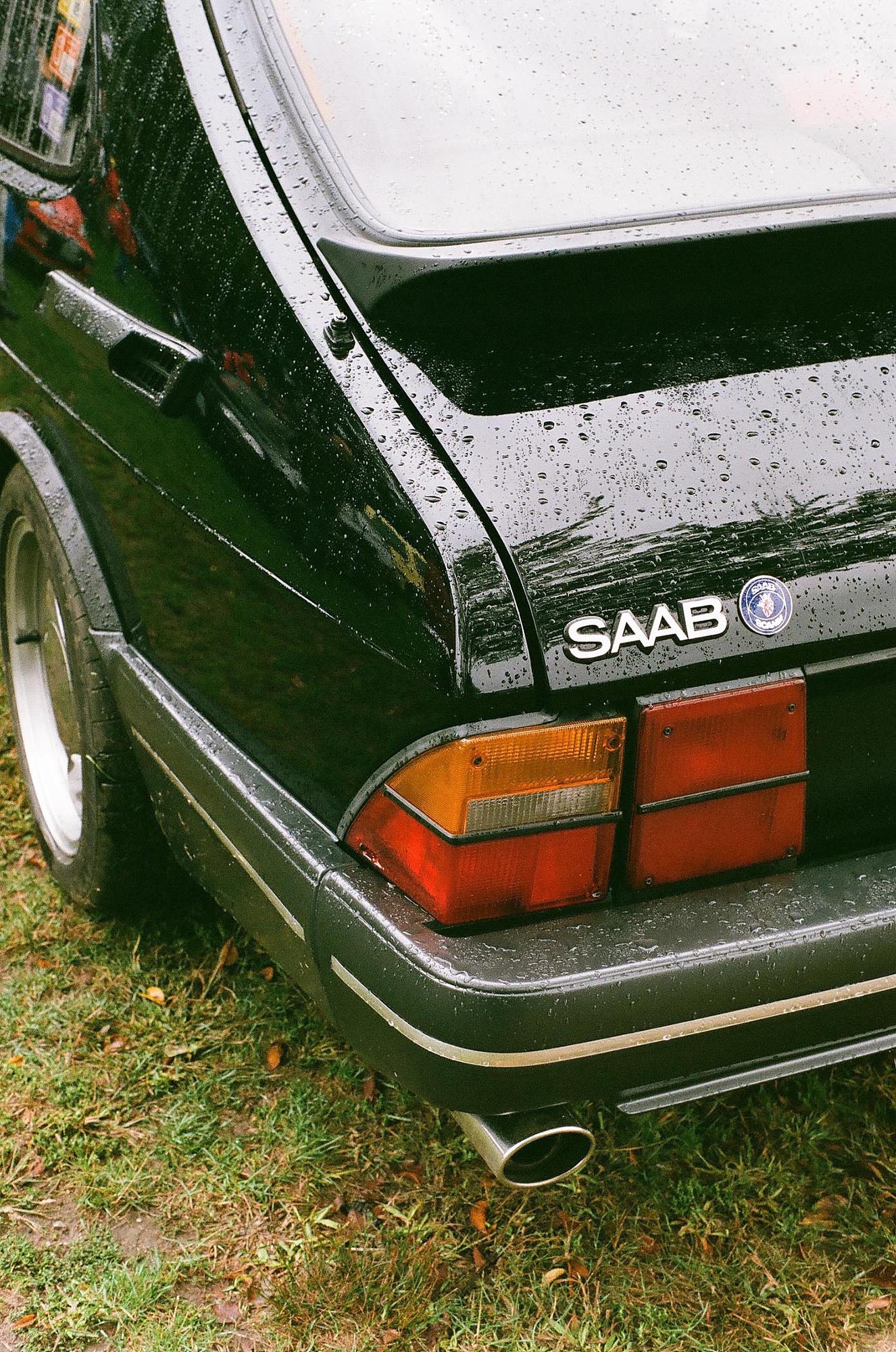 The rear corner of a black Saab 900