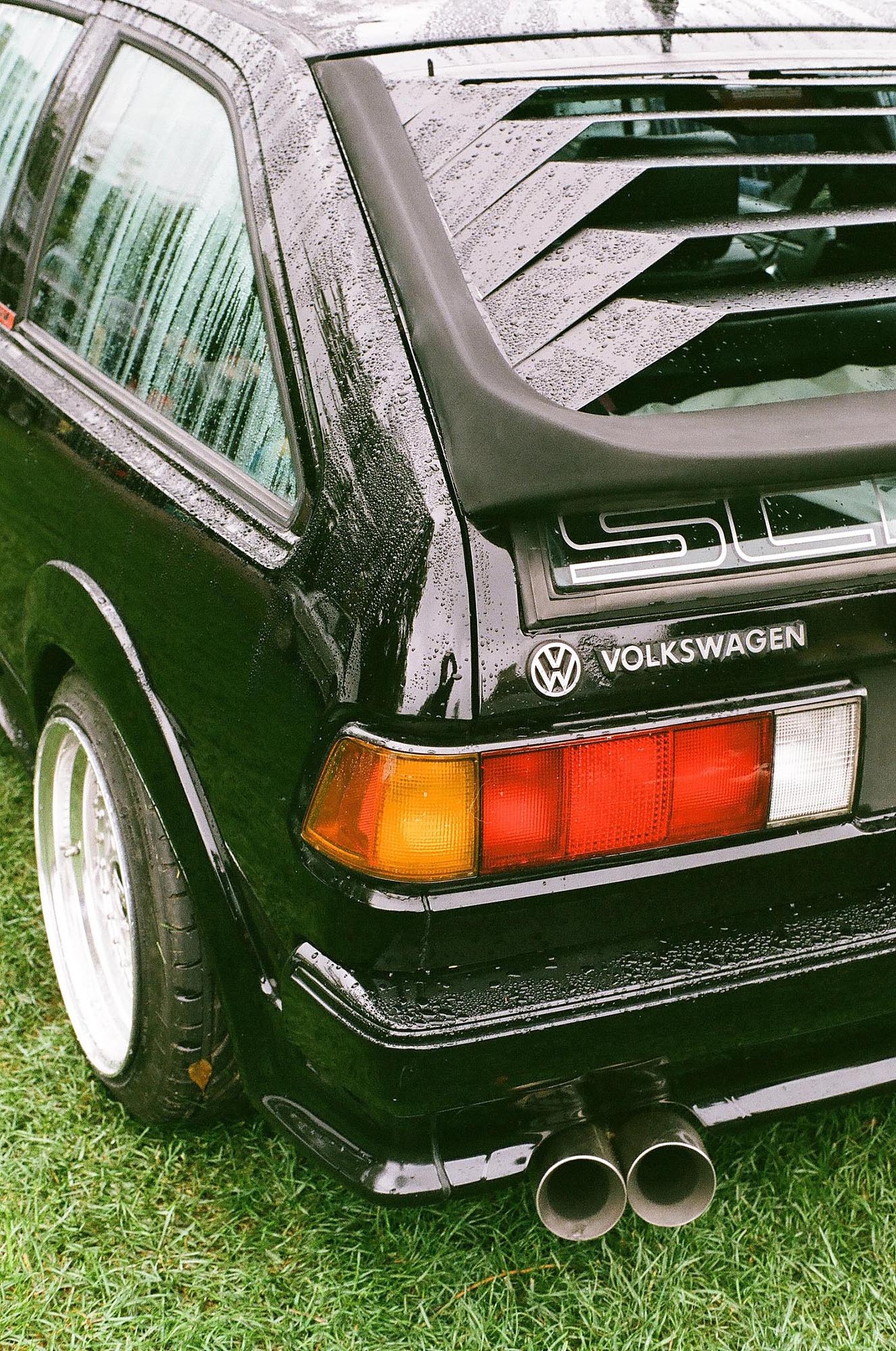 The rear corner of a black VW Scirocco