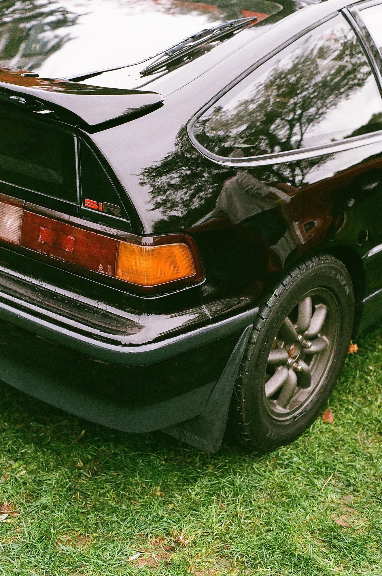 The rear corner of a black Honda CRX