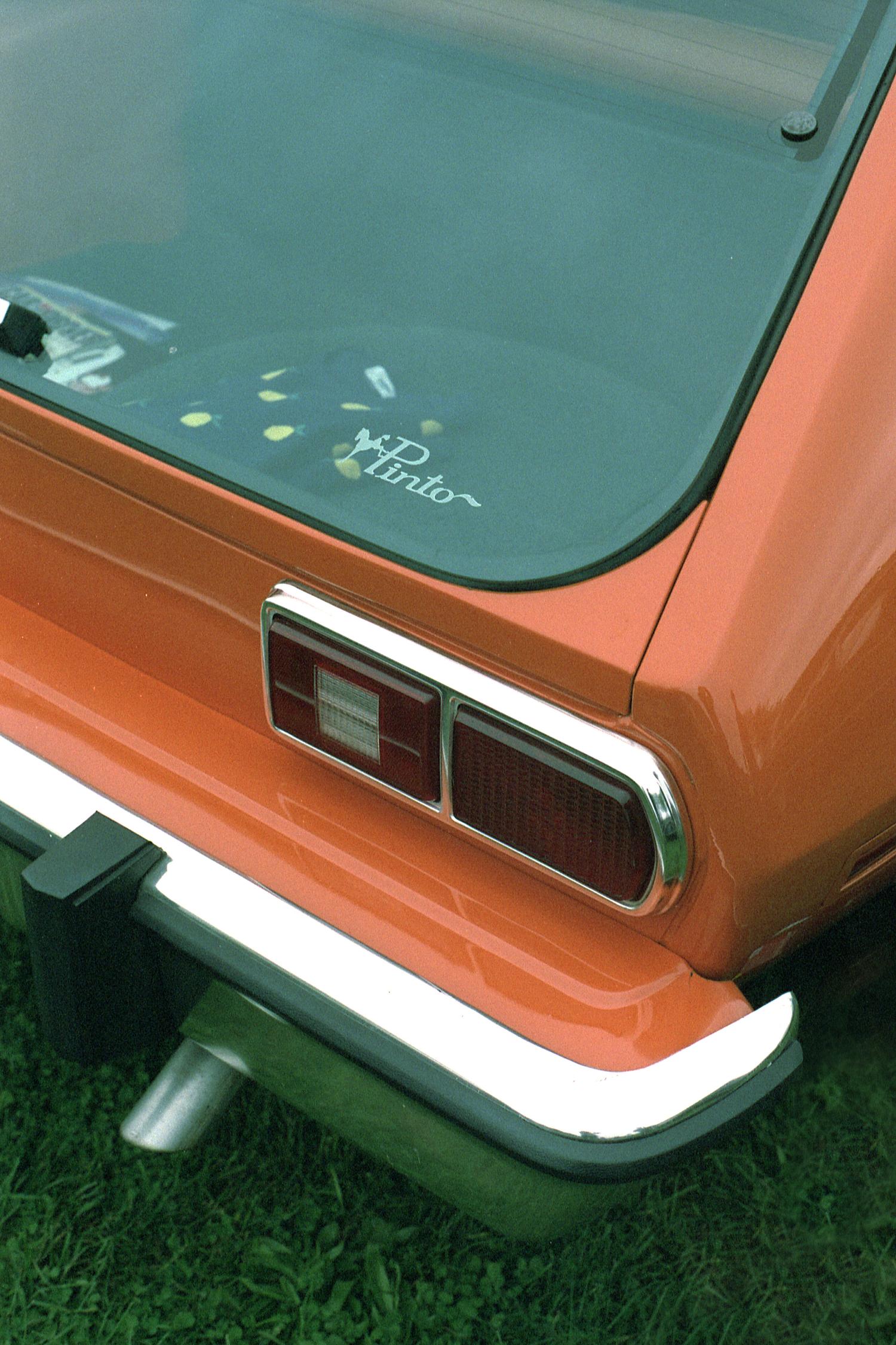 The rear corner of an orange Ford Pinto