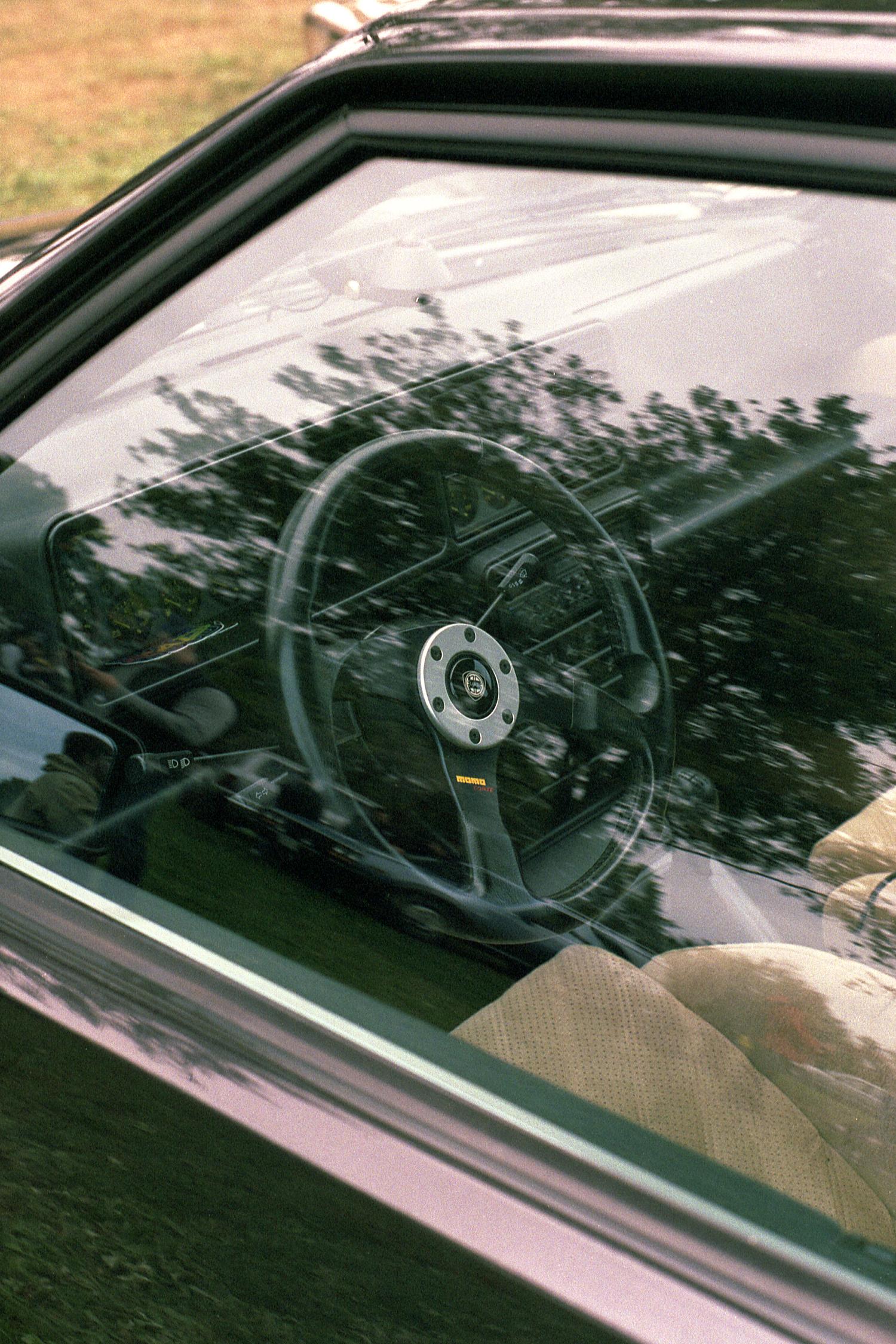 The interior of a Lancia Delta Integrale through the driver's window