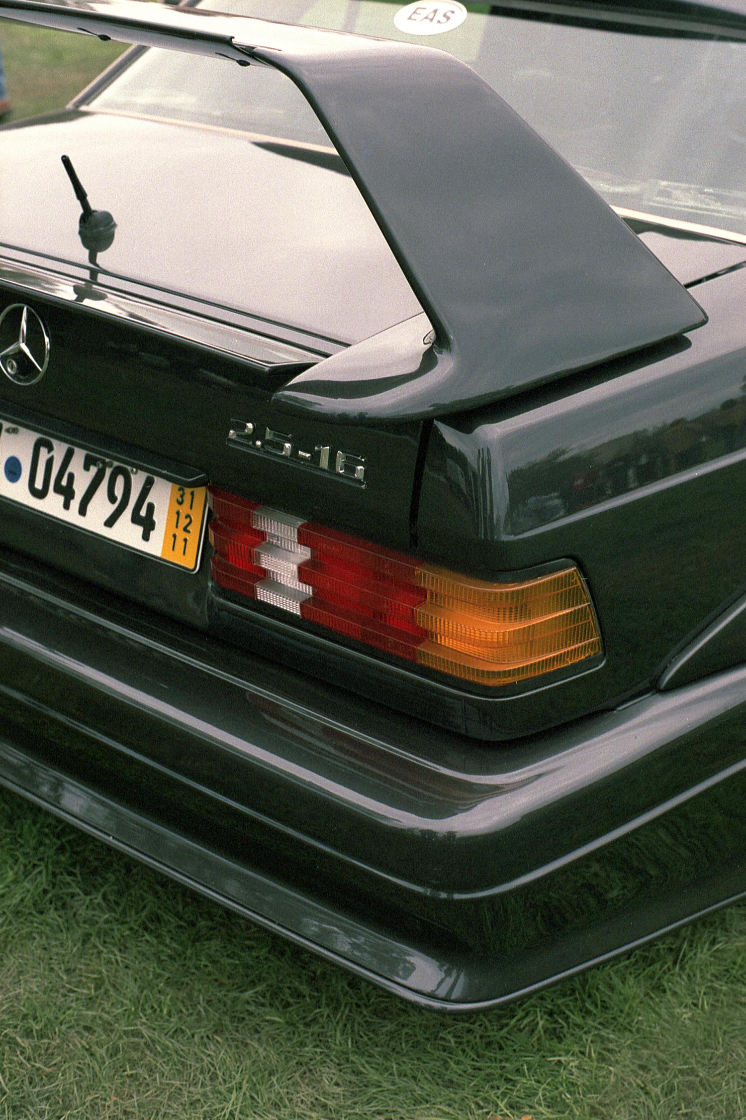 The rear corner of a black Mercedes-Benz 190E