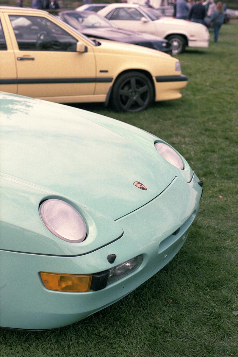 The front of a turquoise Porsche 968 convertible