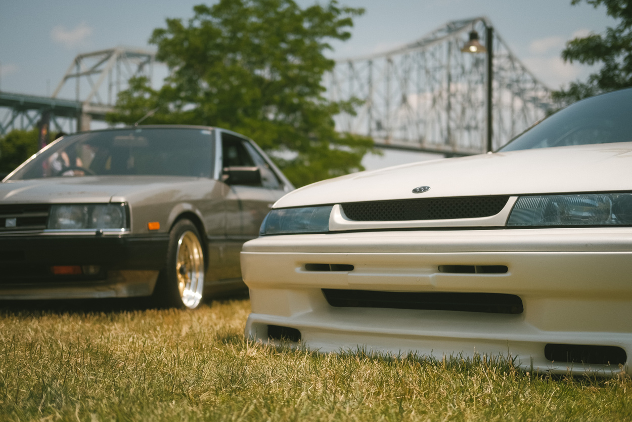 The front ends of a white Subaru SVX and a Nissan Skyline Turbo