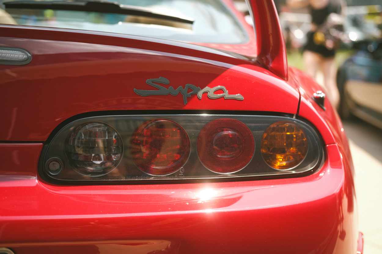 A rear taillight of a red Toyota Supra