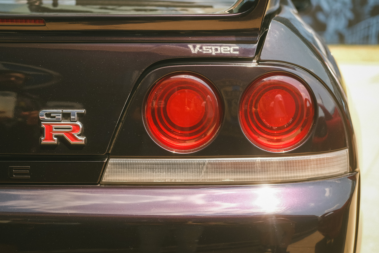 A rear taillight of a purple Nissan Skyline GT-R