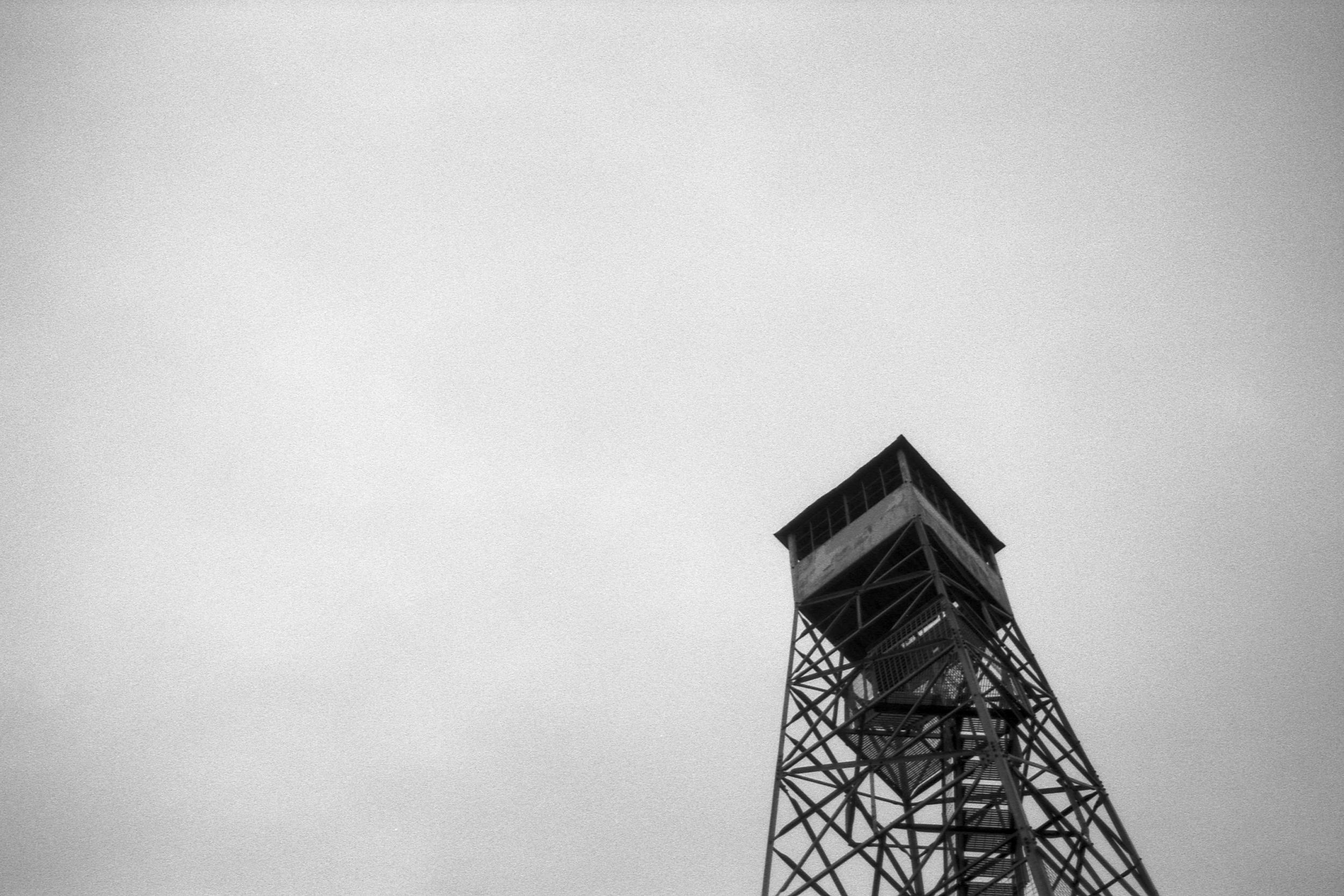 A watchtower against a white sky