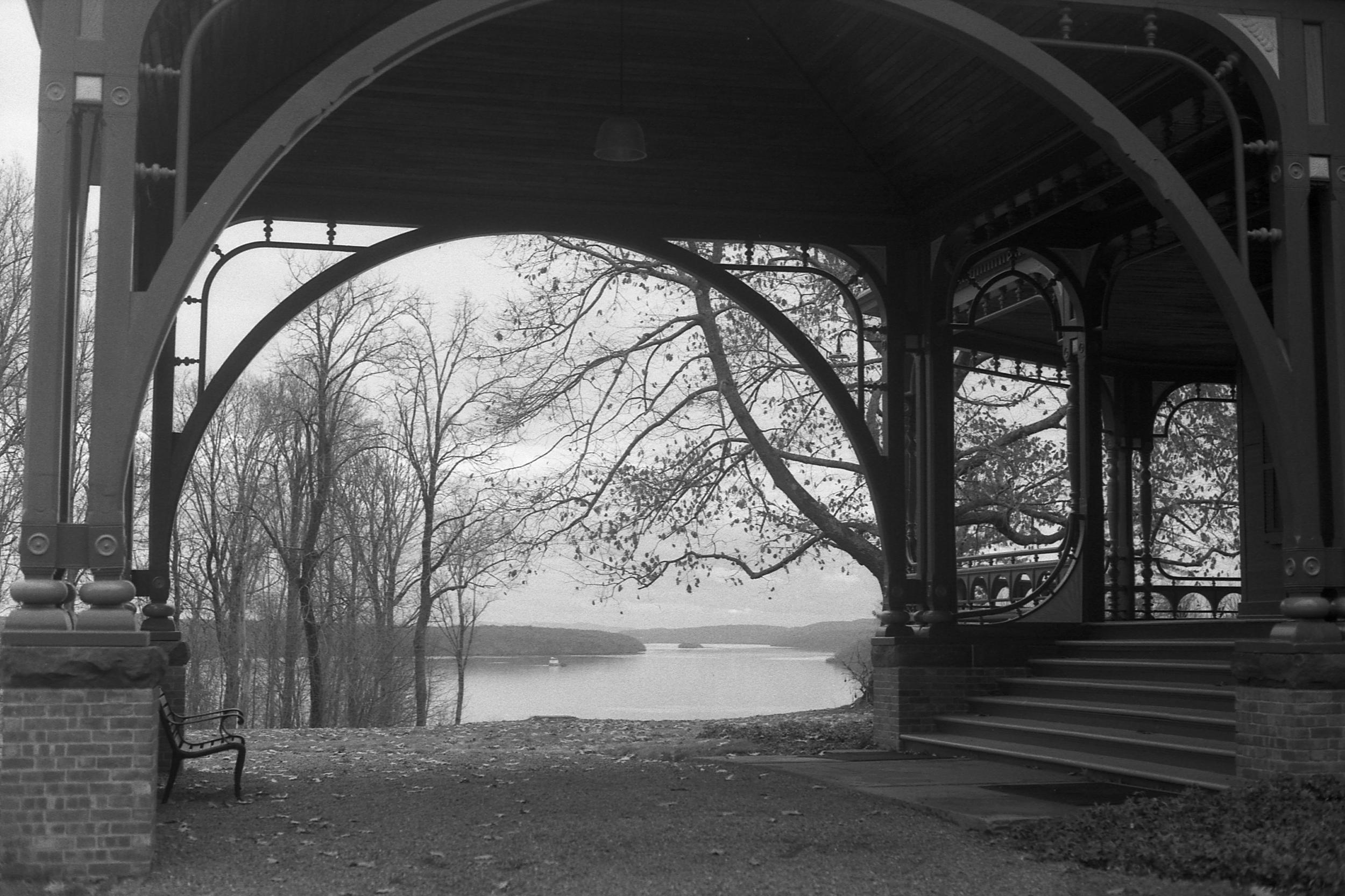 An ornate arch at the Wilderstein mansion with the lake in the distance