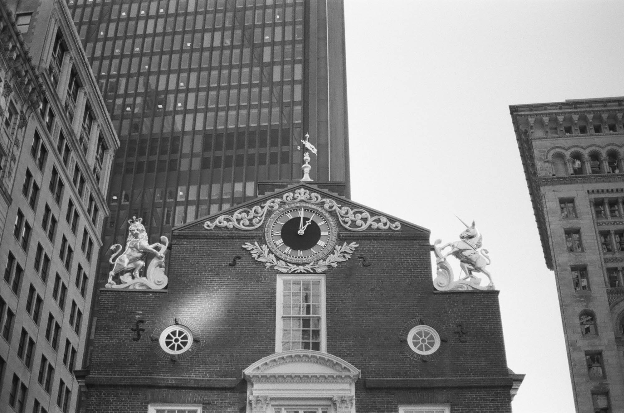 Looking up at the State House with modern skyscrapers in the background
