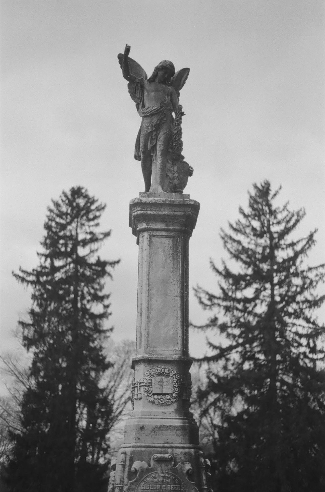 A large grave statutary with a winged angel on top
