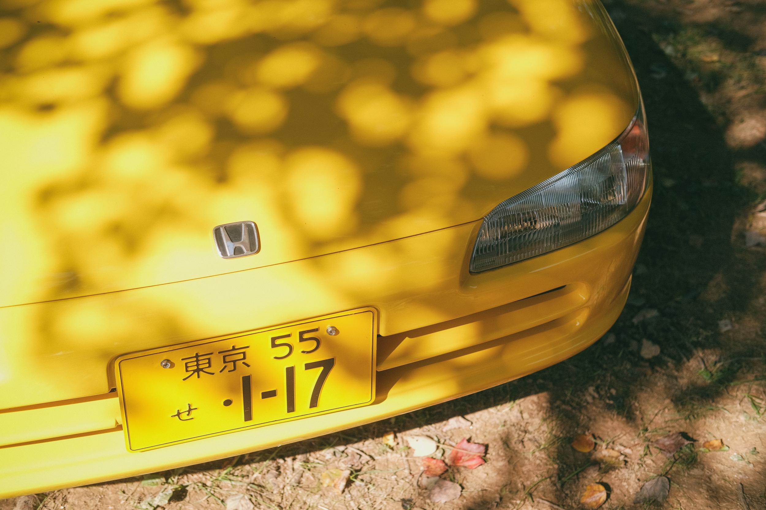 The front of a yellow Honda Beat