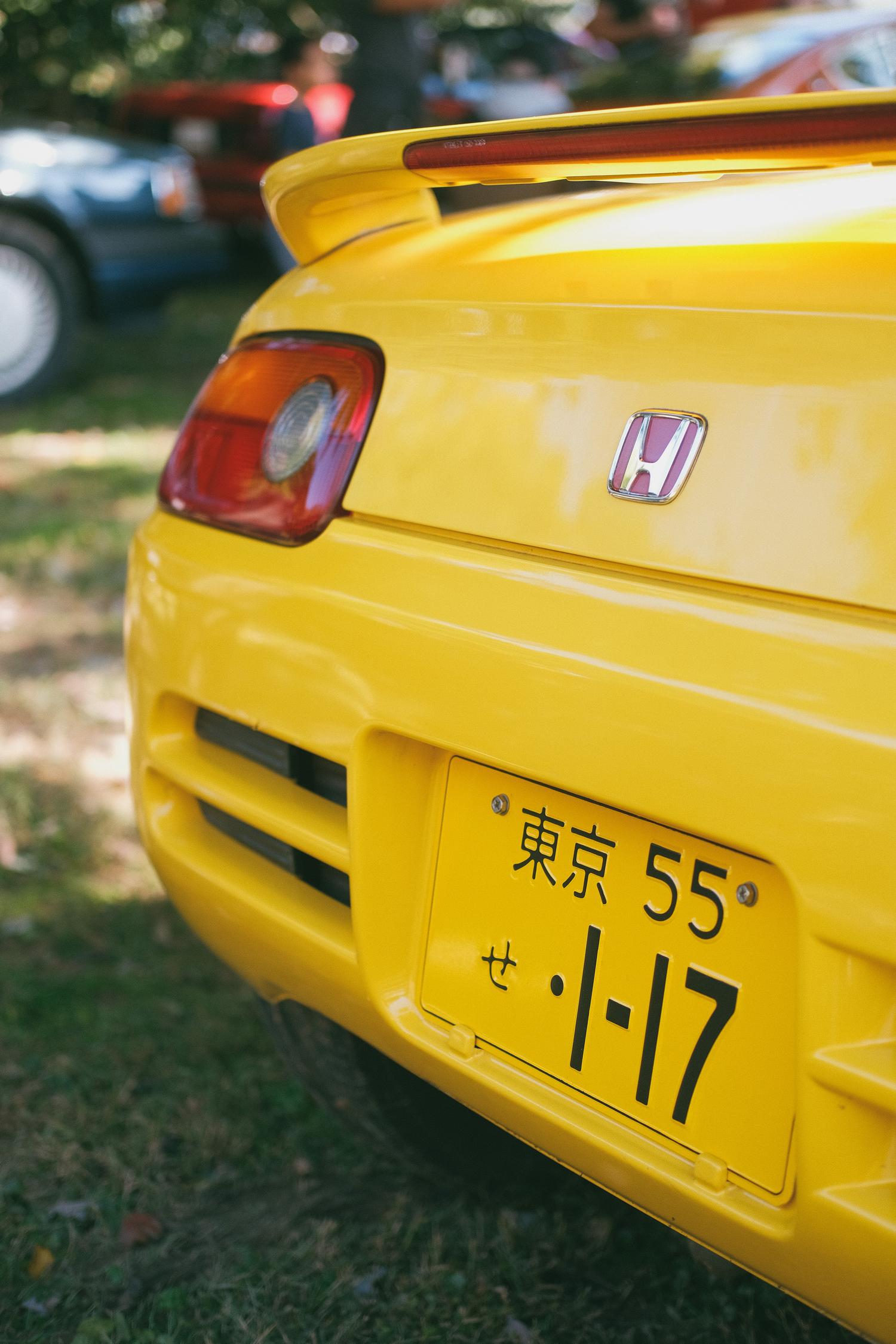 The reat of a yellow Honda Beat