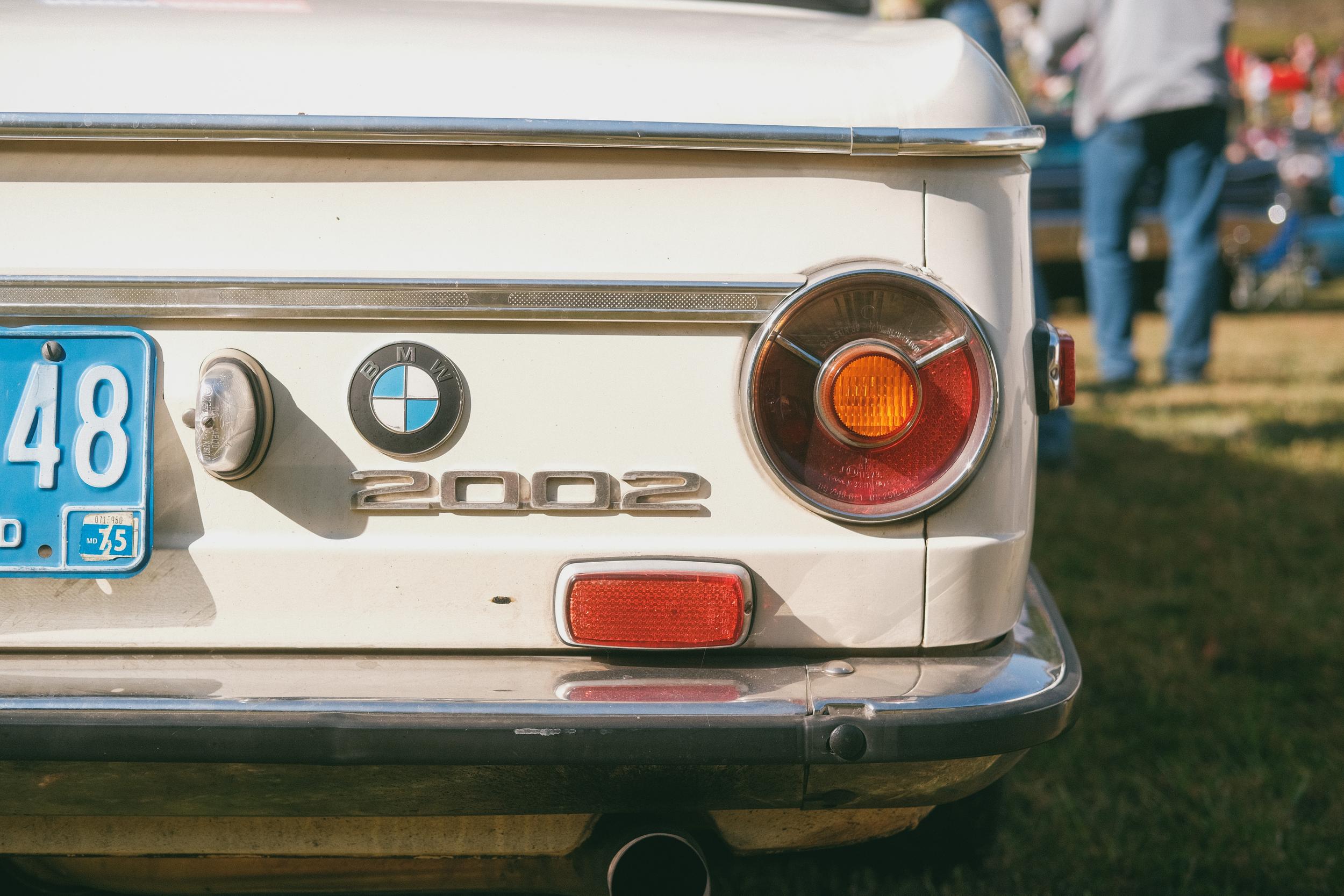 The rear corner of a white BMW 2002