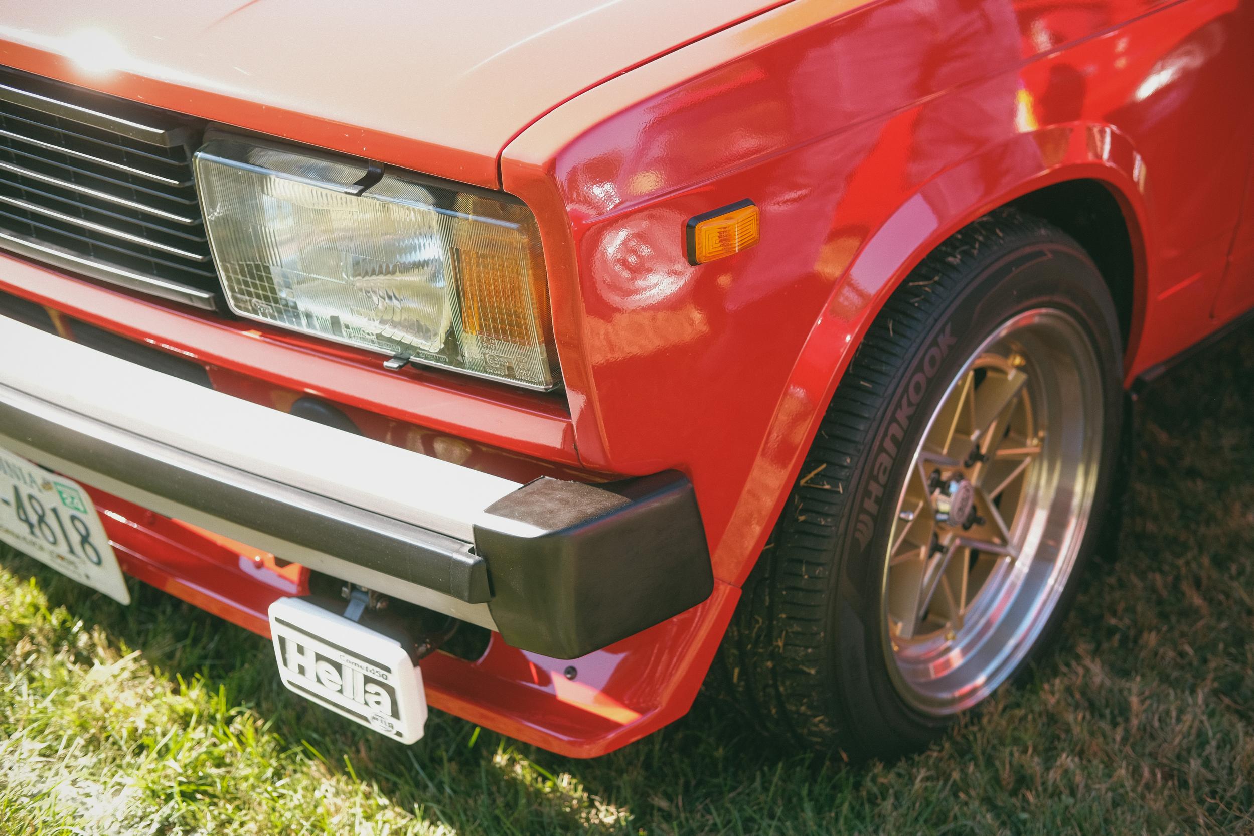 The front corner of a modified red Lada