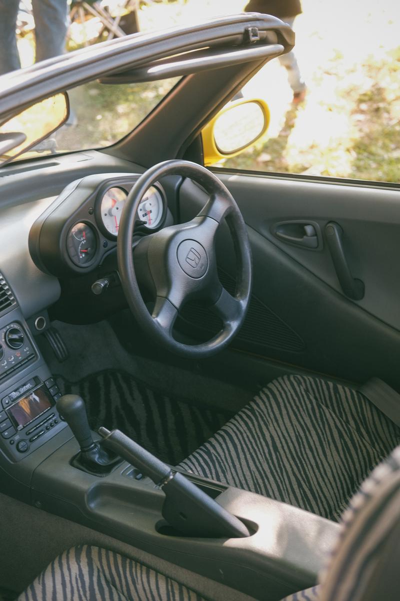 The interior of a Honda Beat, with zebra stripe seats