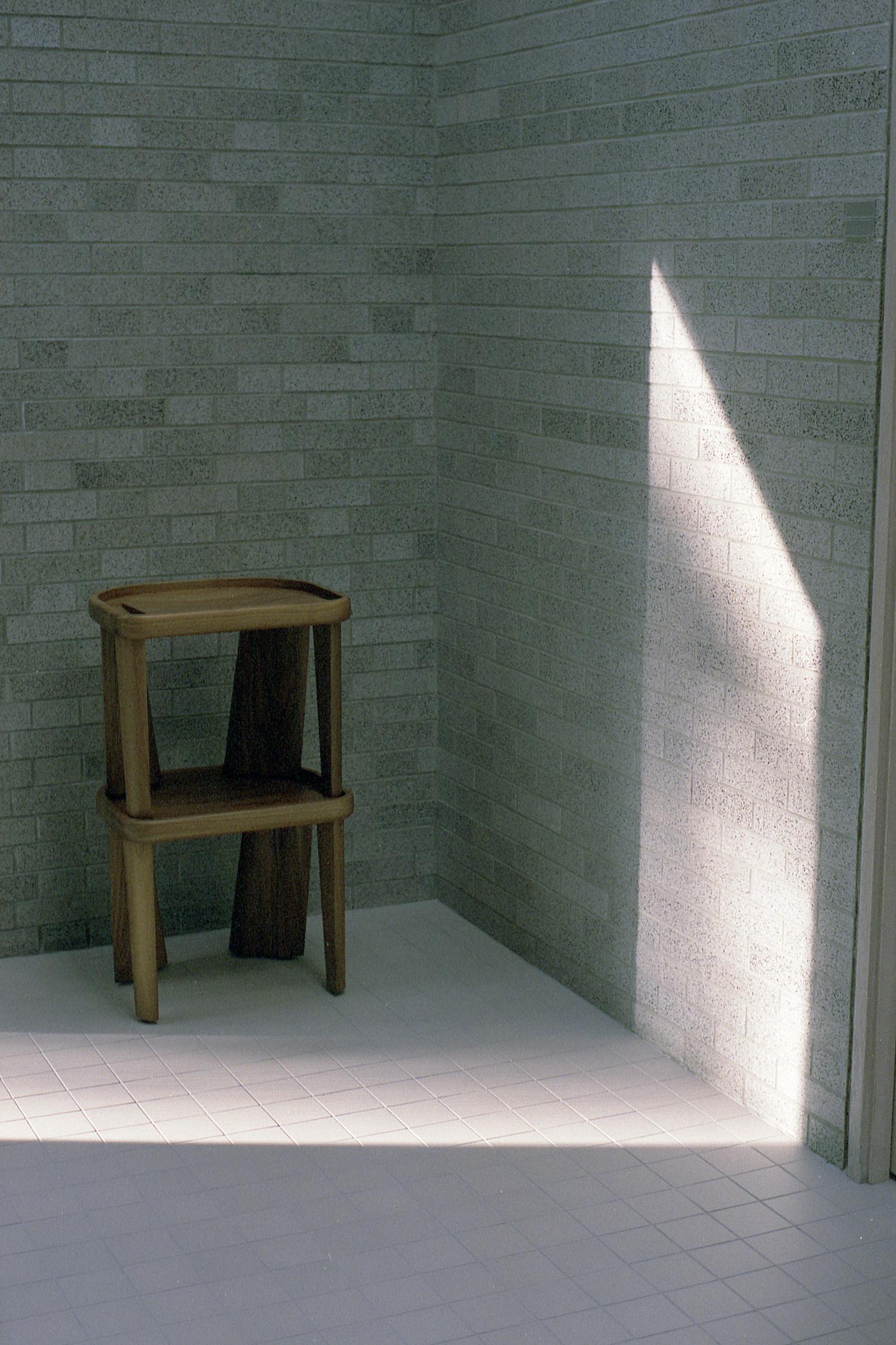 Stacked stools in a corner with a beam of sunlight