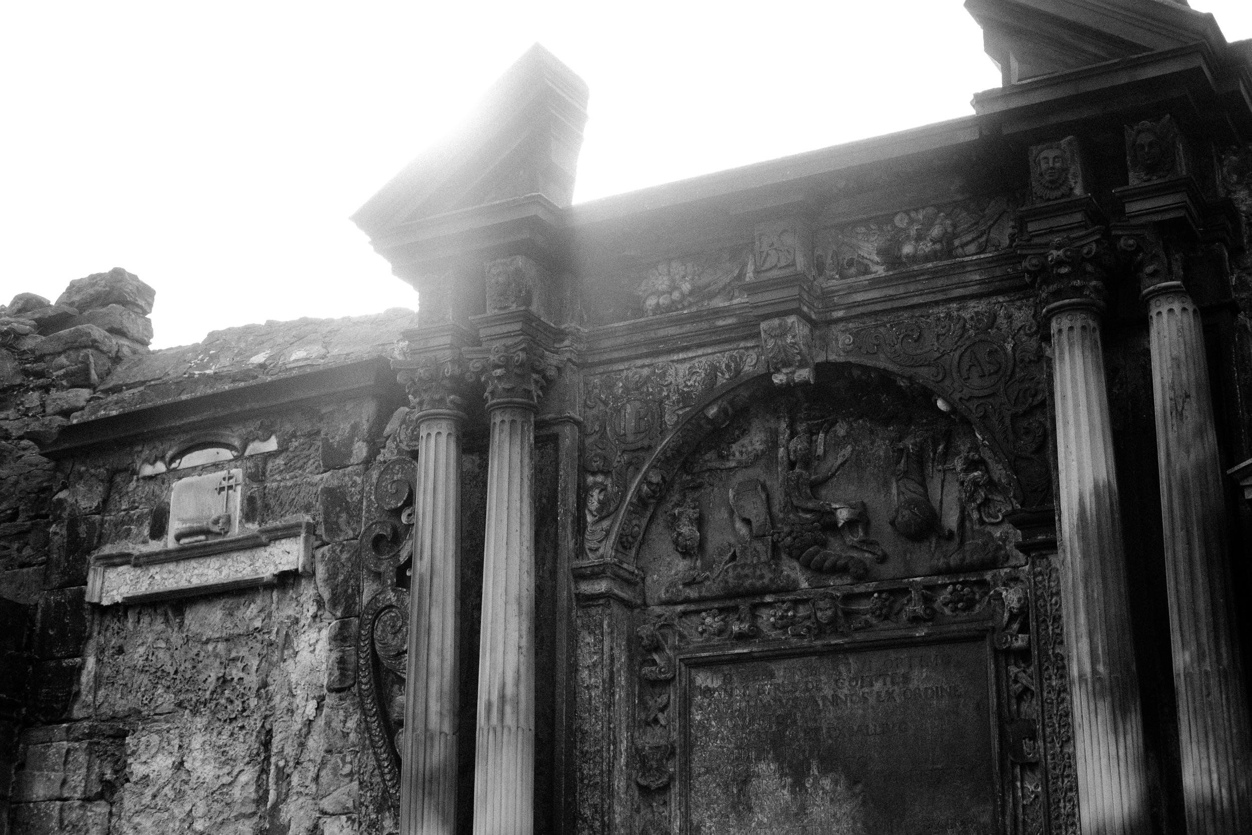 Old grave markers built into a stone wall