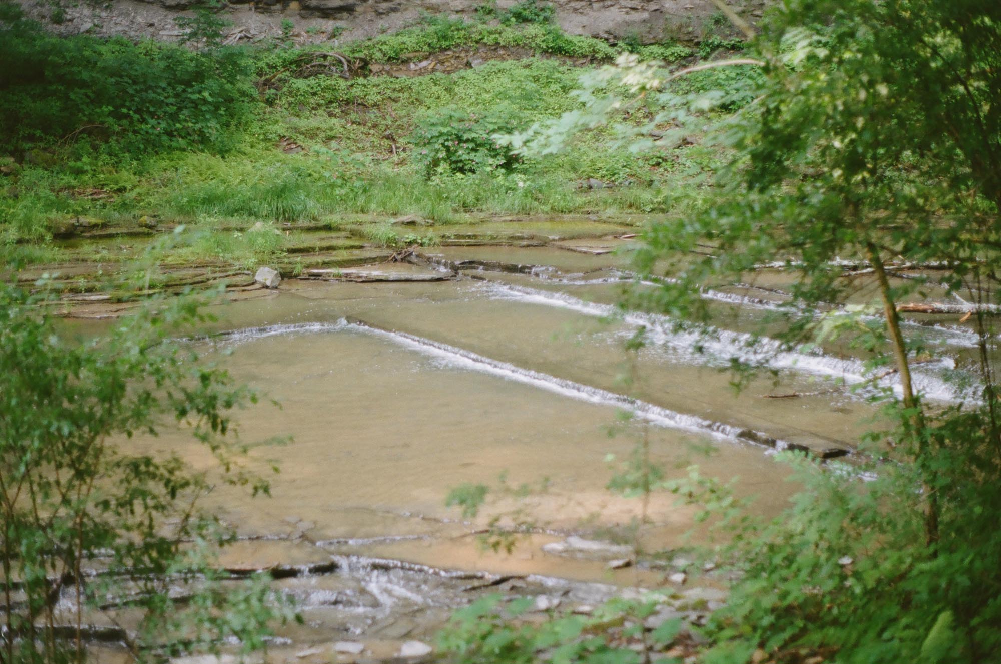 Water cascading down a pond with flat ridges