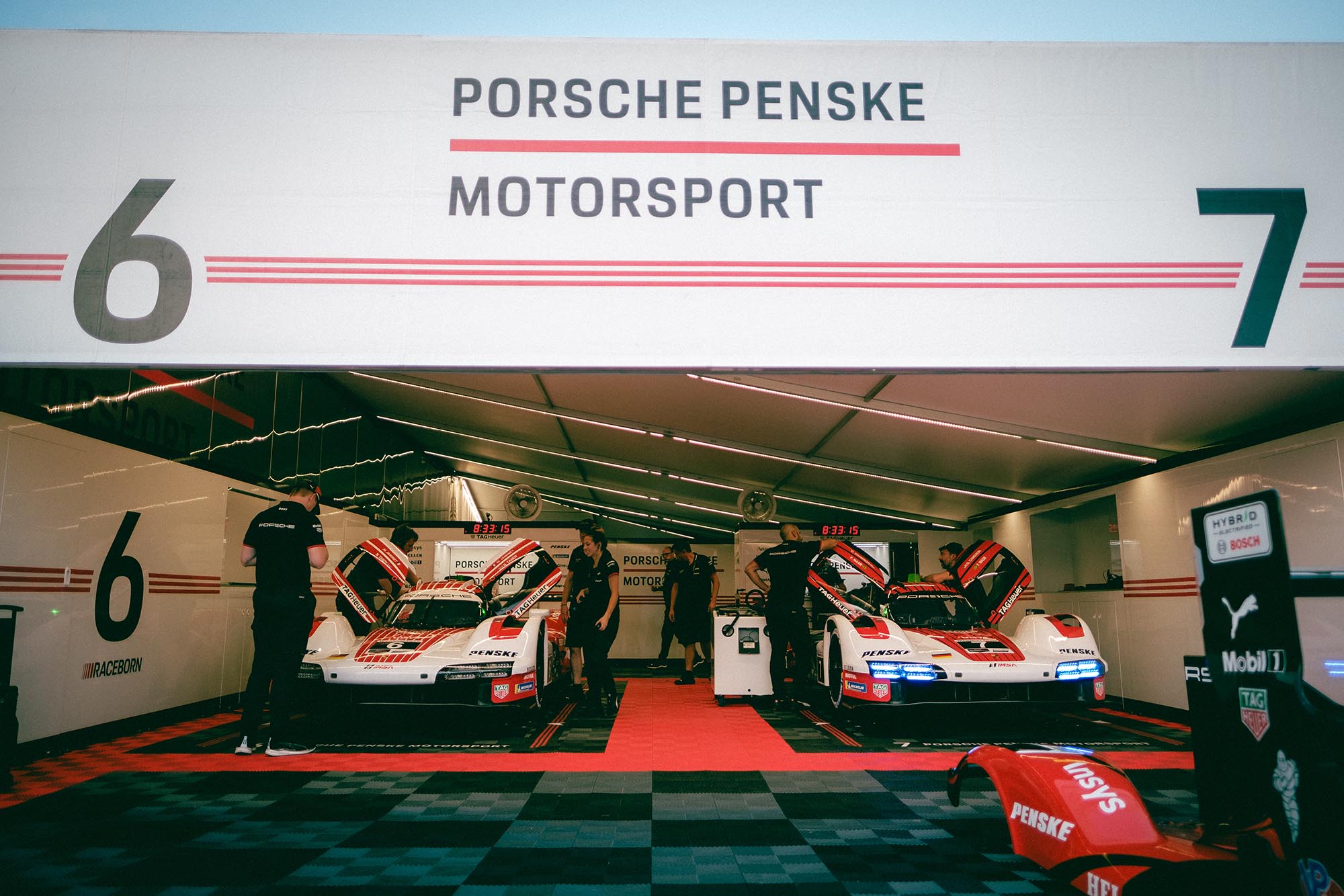 Two Porsche 963s in the paddock