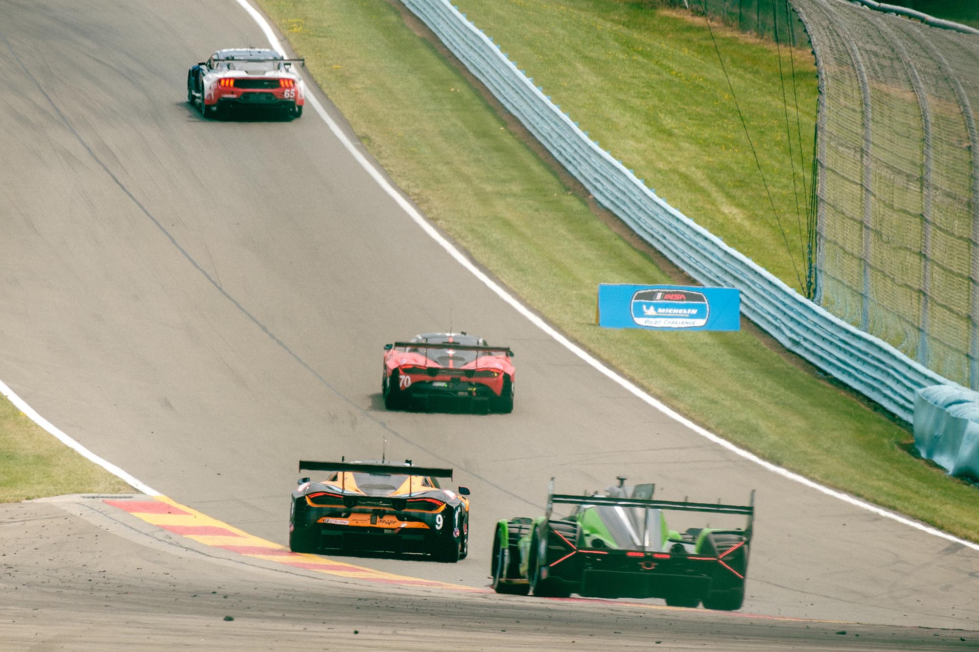 Cars racing up the hill into Turn 10