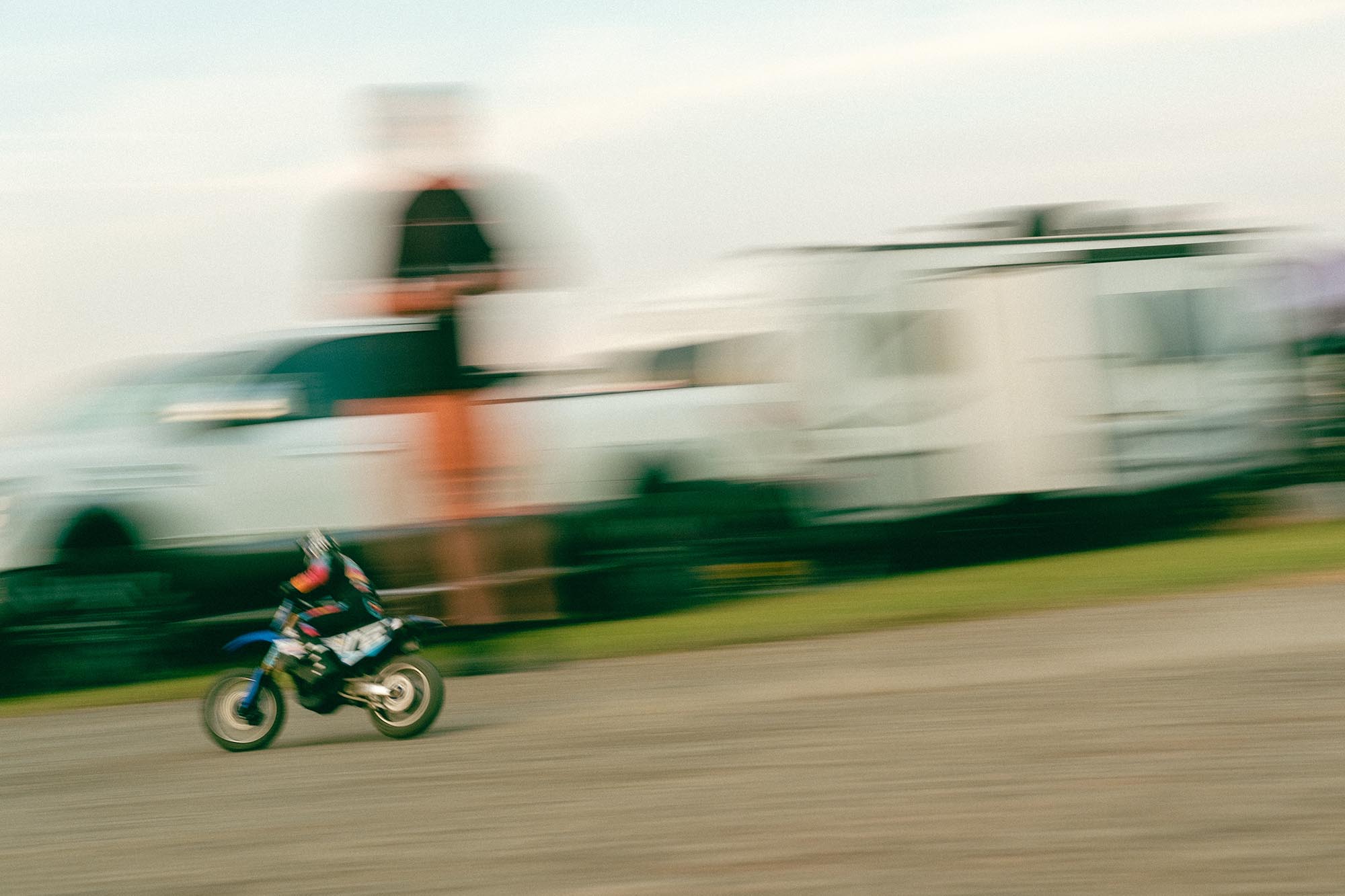 An RC dirt bike racing through the campground