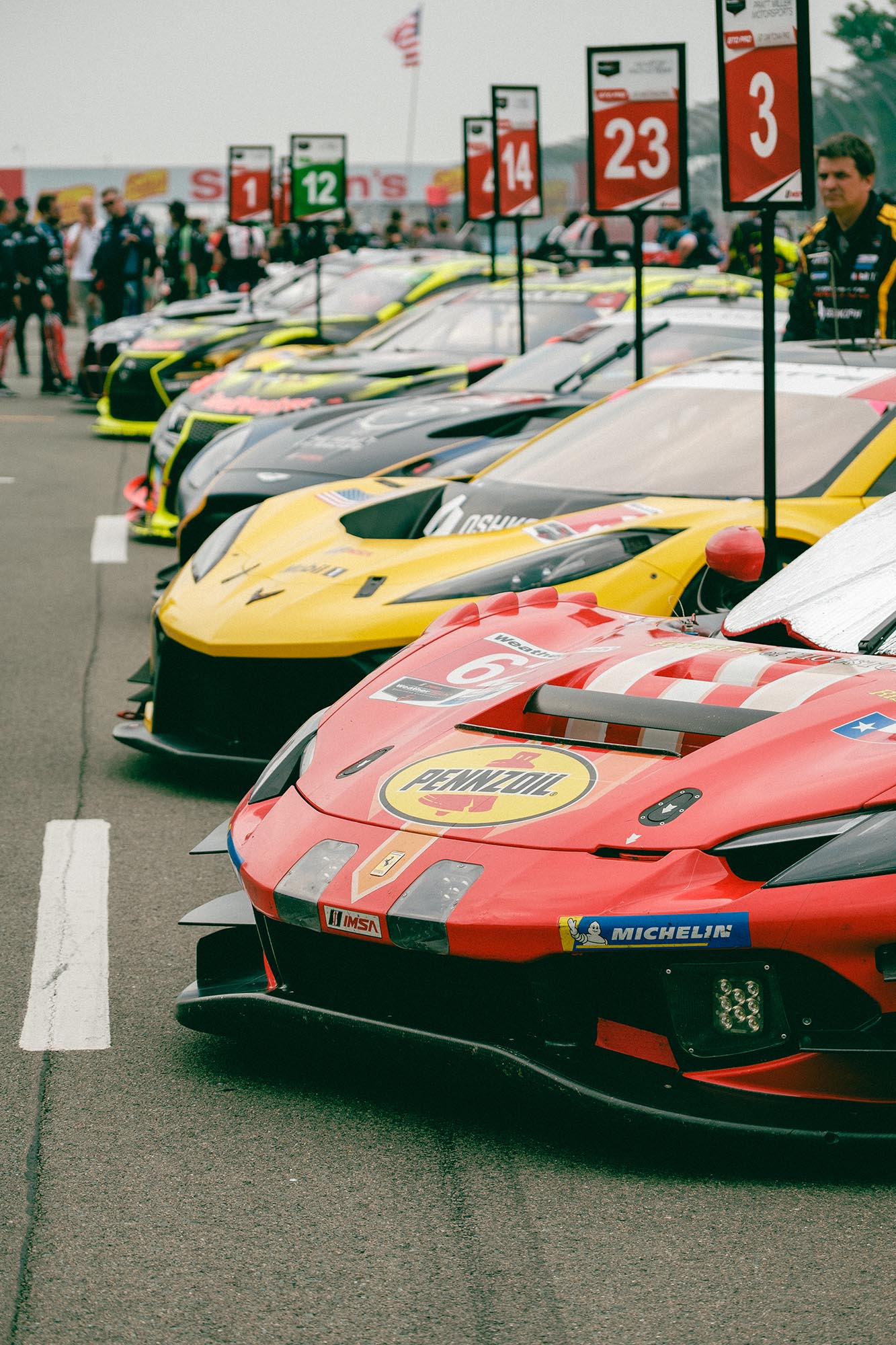 Race cars lined up in pit lane