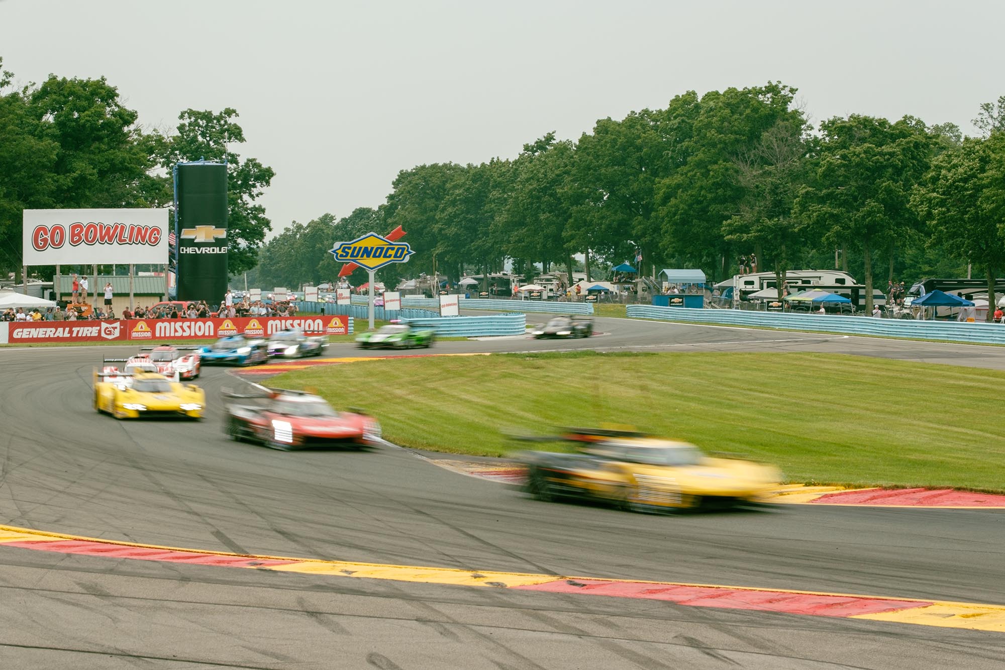 Blurred cars driving through the Bus Stop chicane