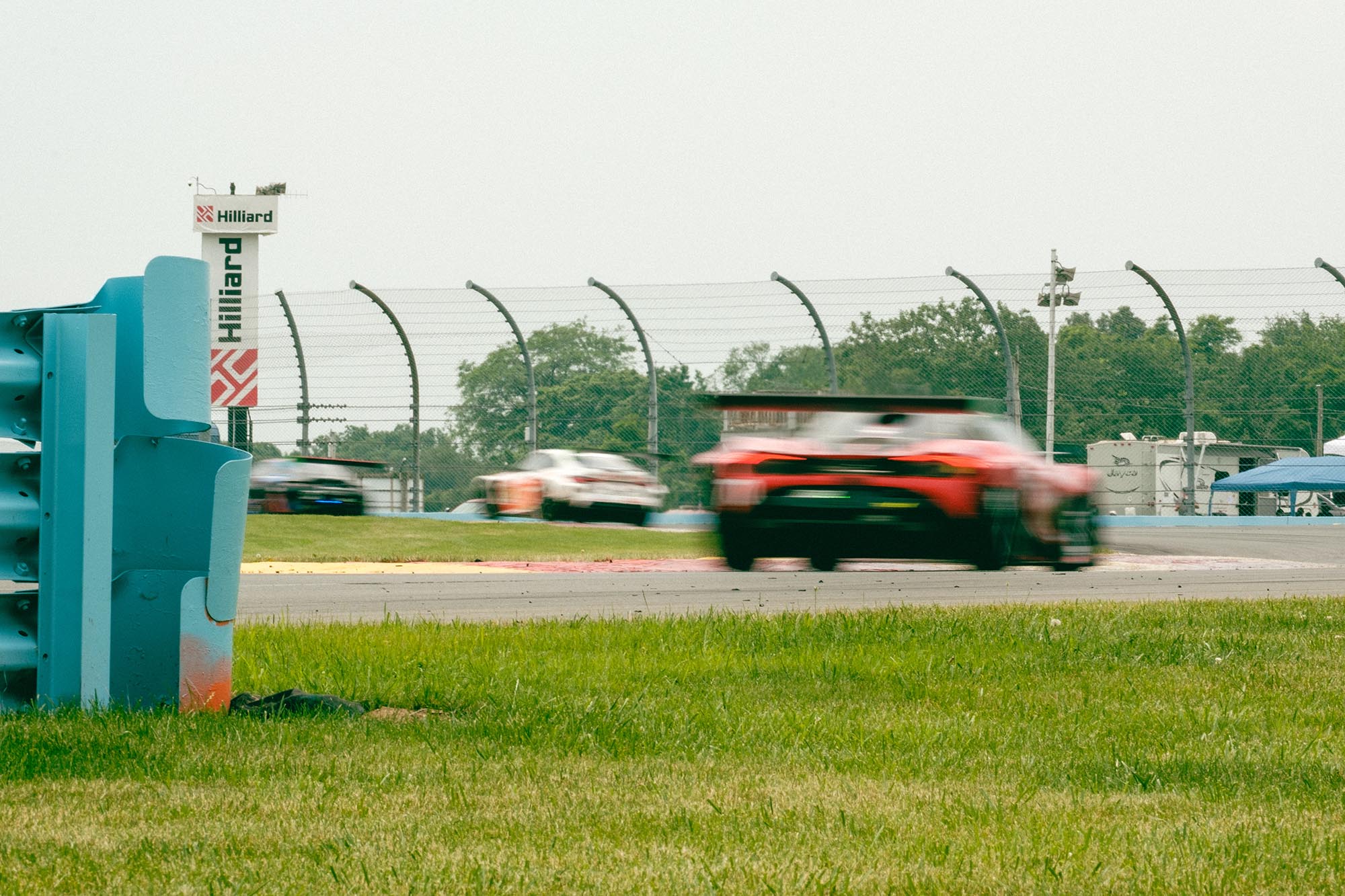 Blurred cars driving through the Bus Stop chicane