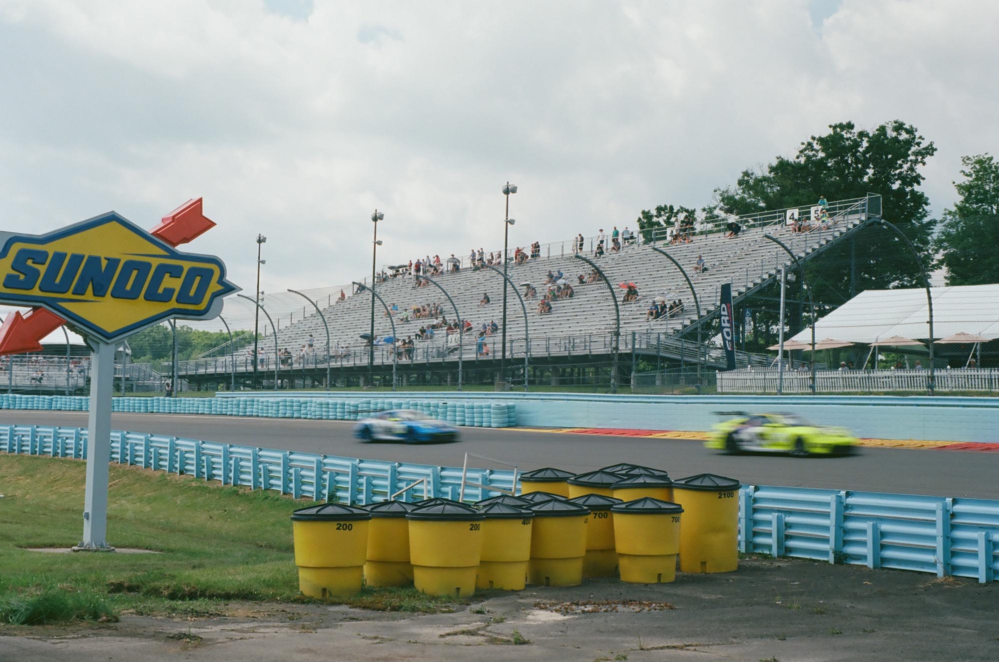 Porsche cup cars driving in front of the grandstand