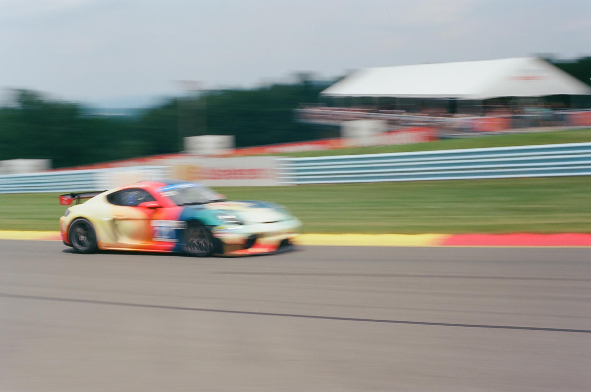 A Porsche 718 race car on track, blurry