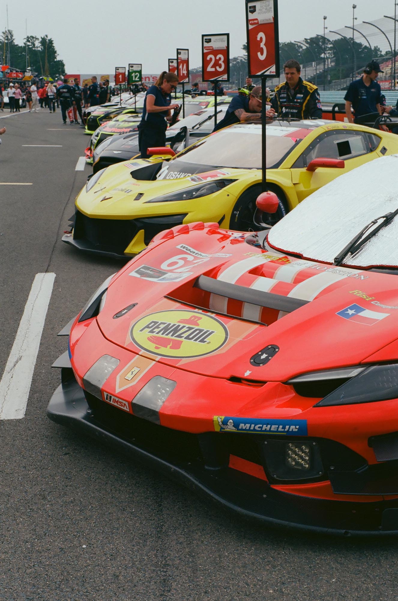 GT race cars lined up in pit lane