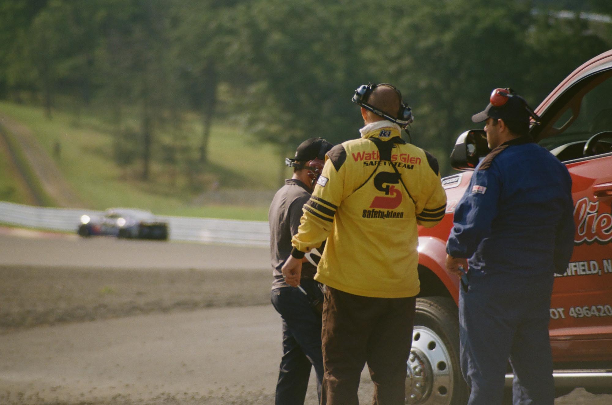 Safety Team members trackside, one of them smoking a cigarette